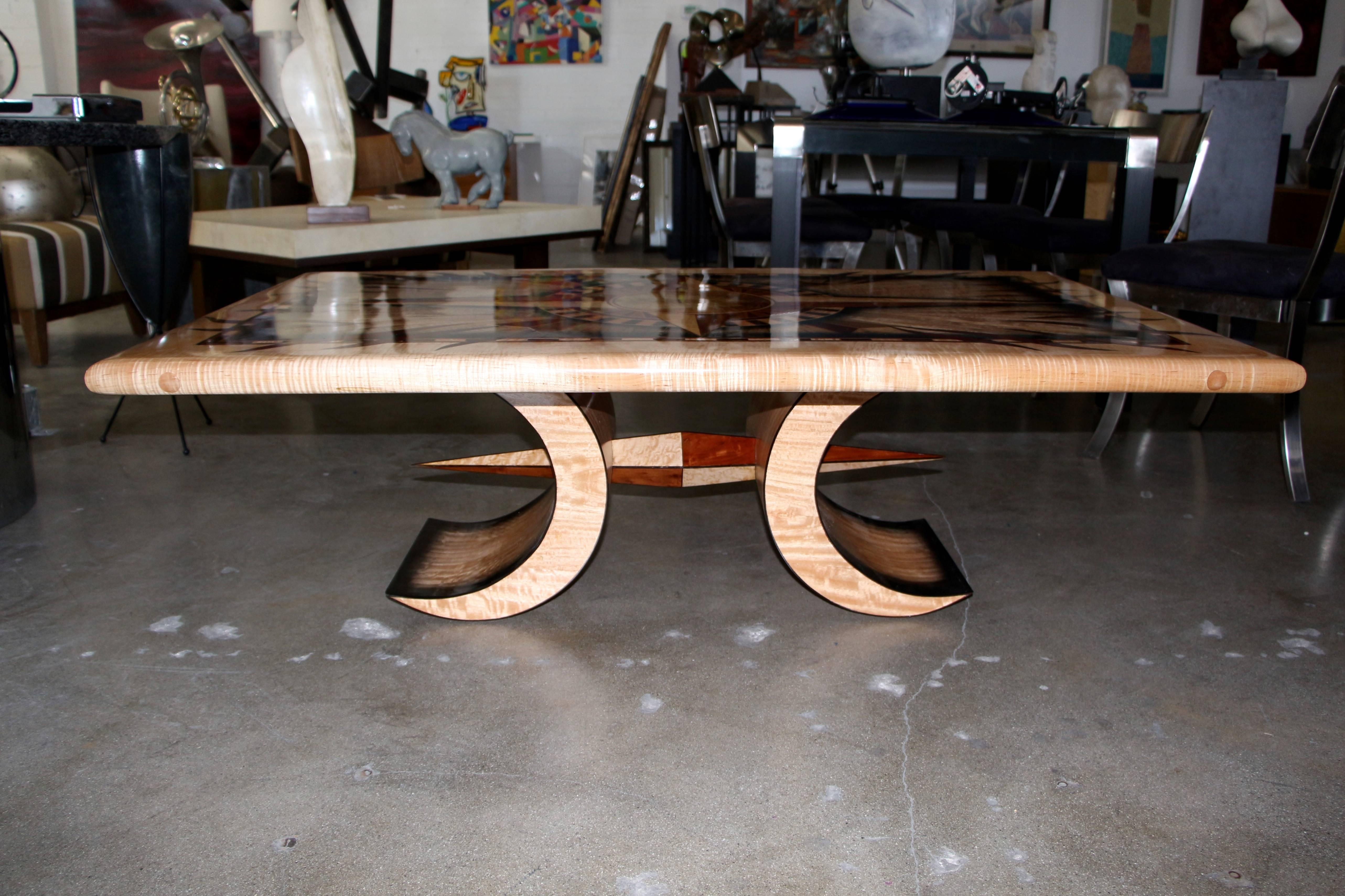 A beautifully made inlaid coffee table by a master wood worker Curtis Underwood. It is truly a spectacular piece made with all sorts of exotic woods, listed next to his signature on the underside. It is a one of a kind piece. Dated December 2011.