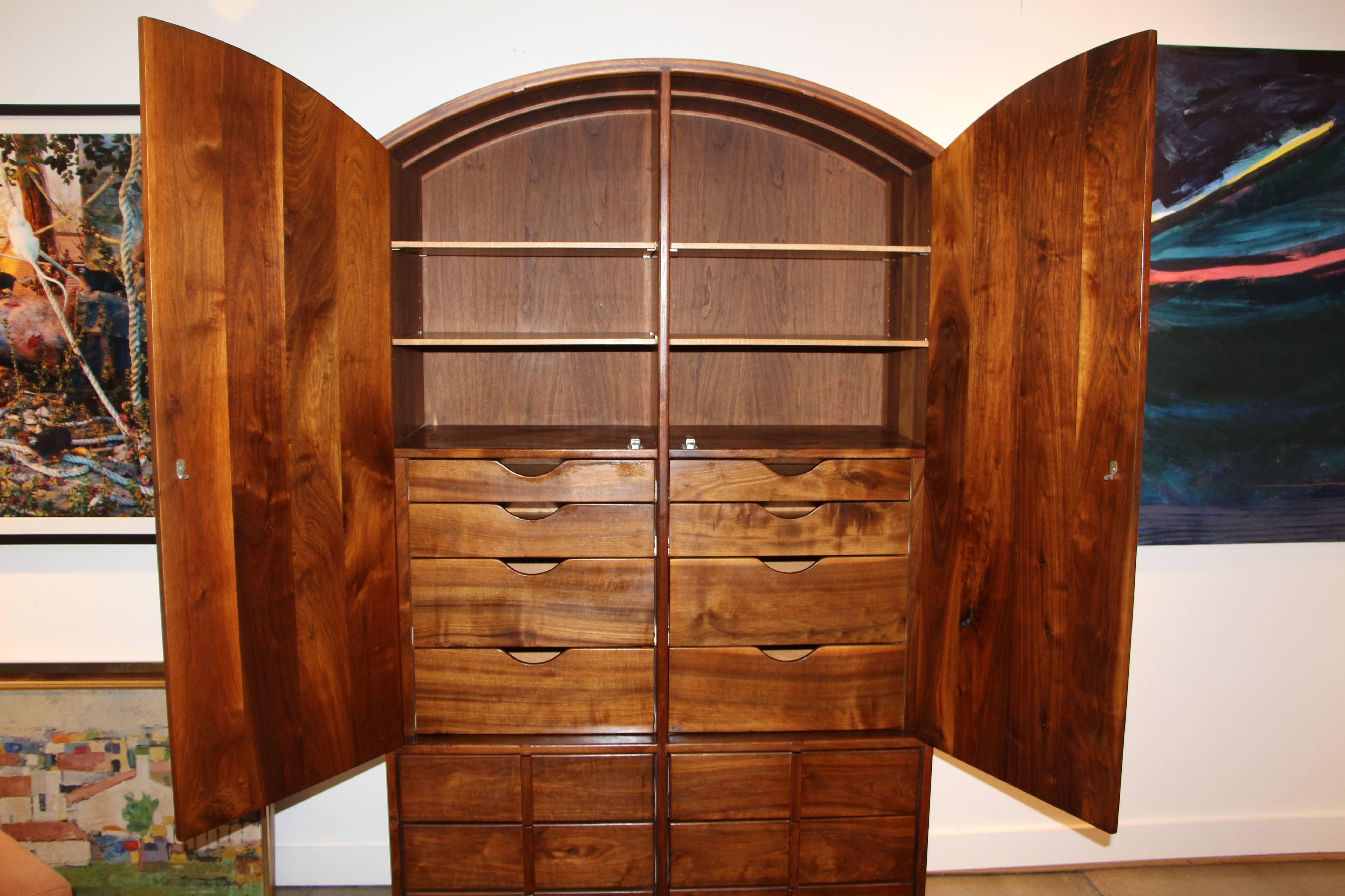 A stunning John Nyquist armoire out of a bedroom suite we just acquired. It is spectacularly grained. I believe the wood is walnut. We do not have the original receipt for this but we do for the night stands. This piece dates to 1979, when it was