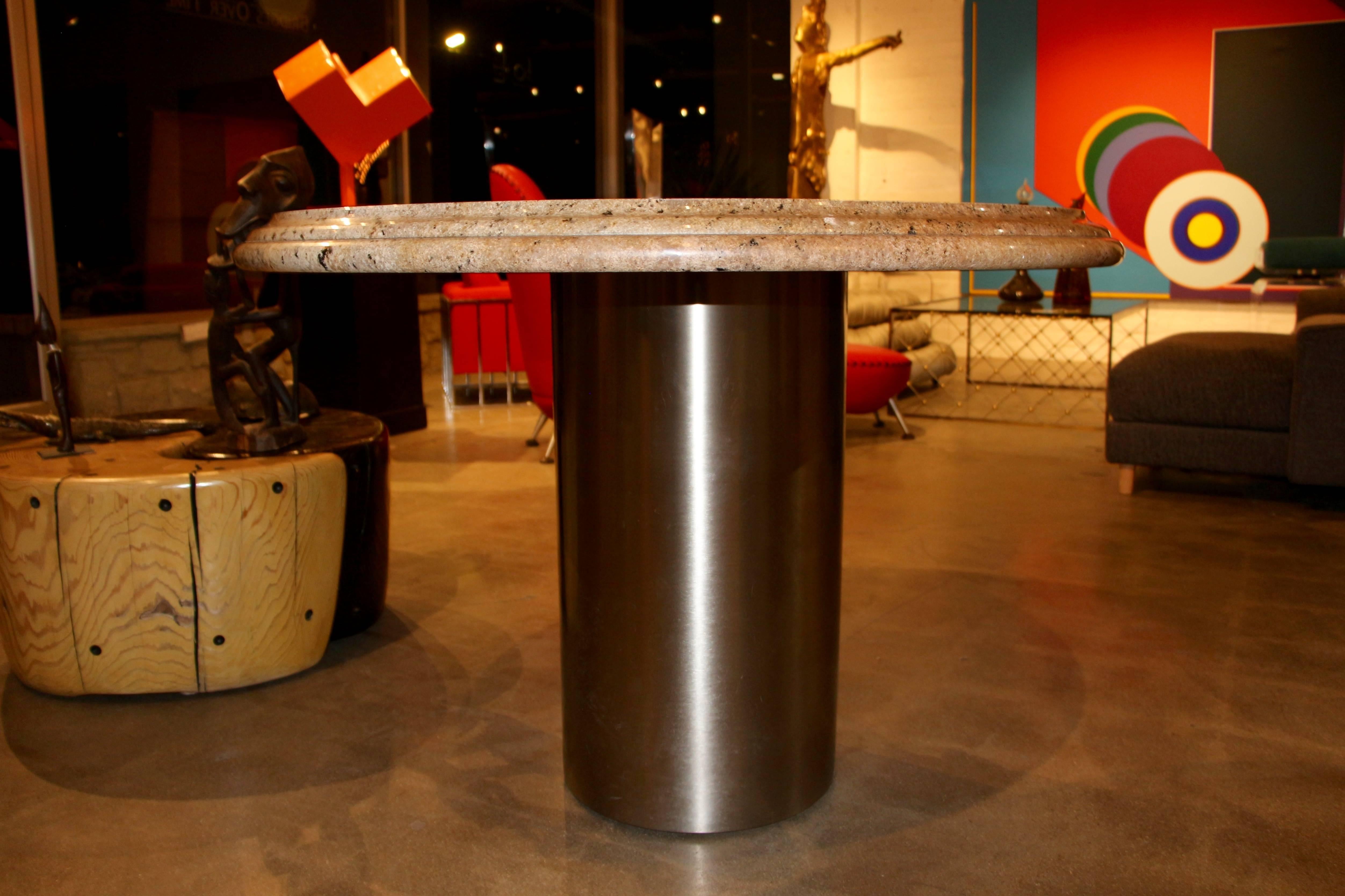 A nice centre table or dining table from the Pace Collection, with a brushed steel base and a granite top with a rounded stepped bullet edge. Both the base and top are extremely heavy and well made. Top is not attached to the base, but due to the