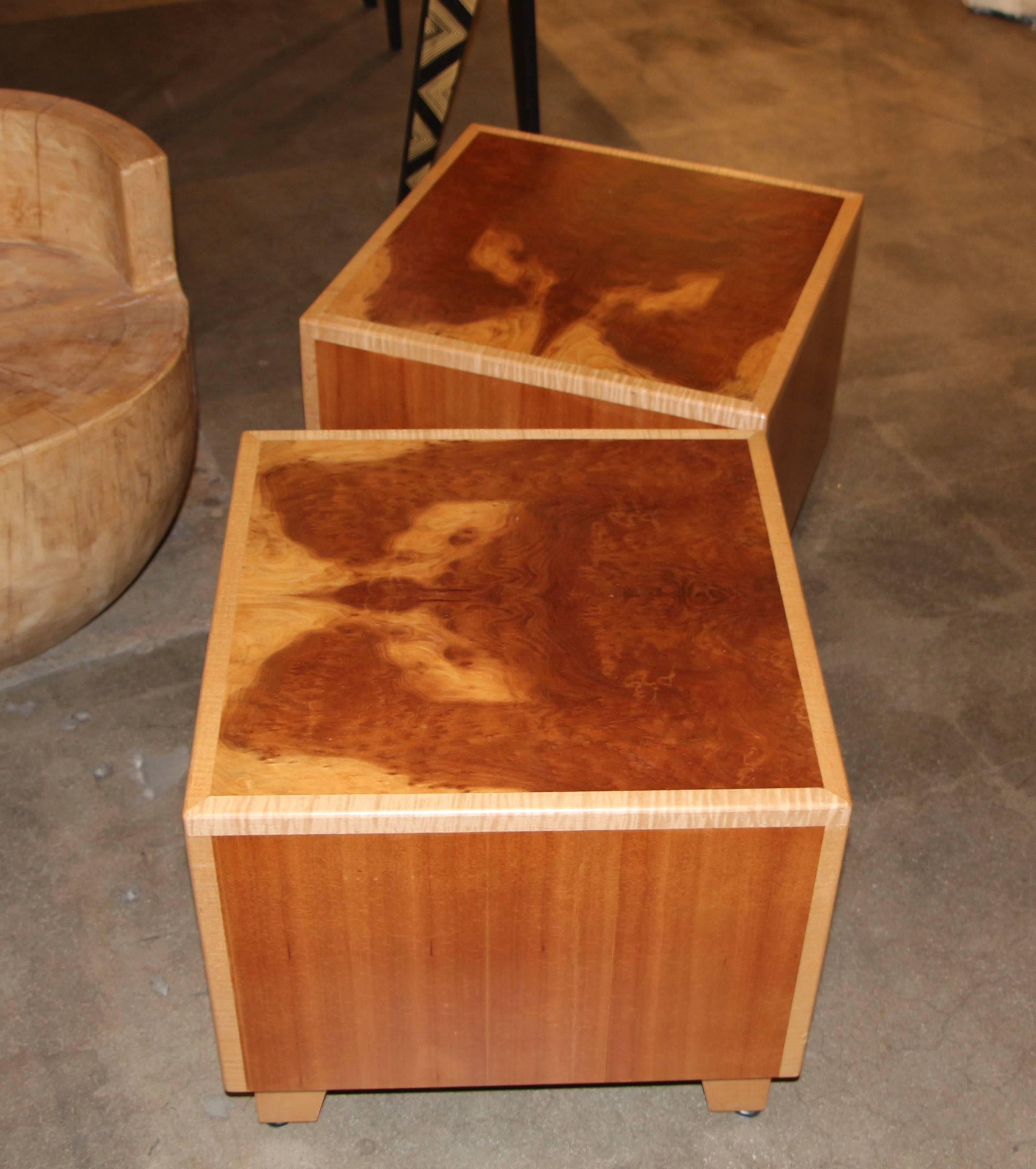 A pair of beautiful tables made by the noted wood artisan Joseph Kelly. He owns and founded the company in 1990. They custom make beautiful furniture. Based on the label this pair looks to be from a charity auction. The tables are made of burl