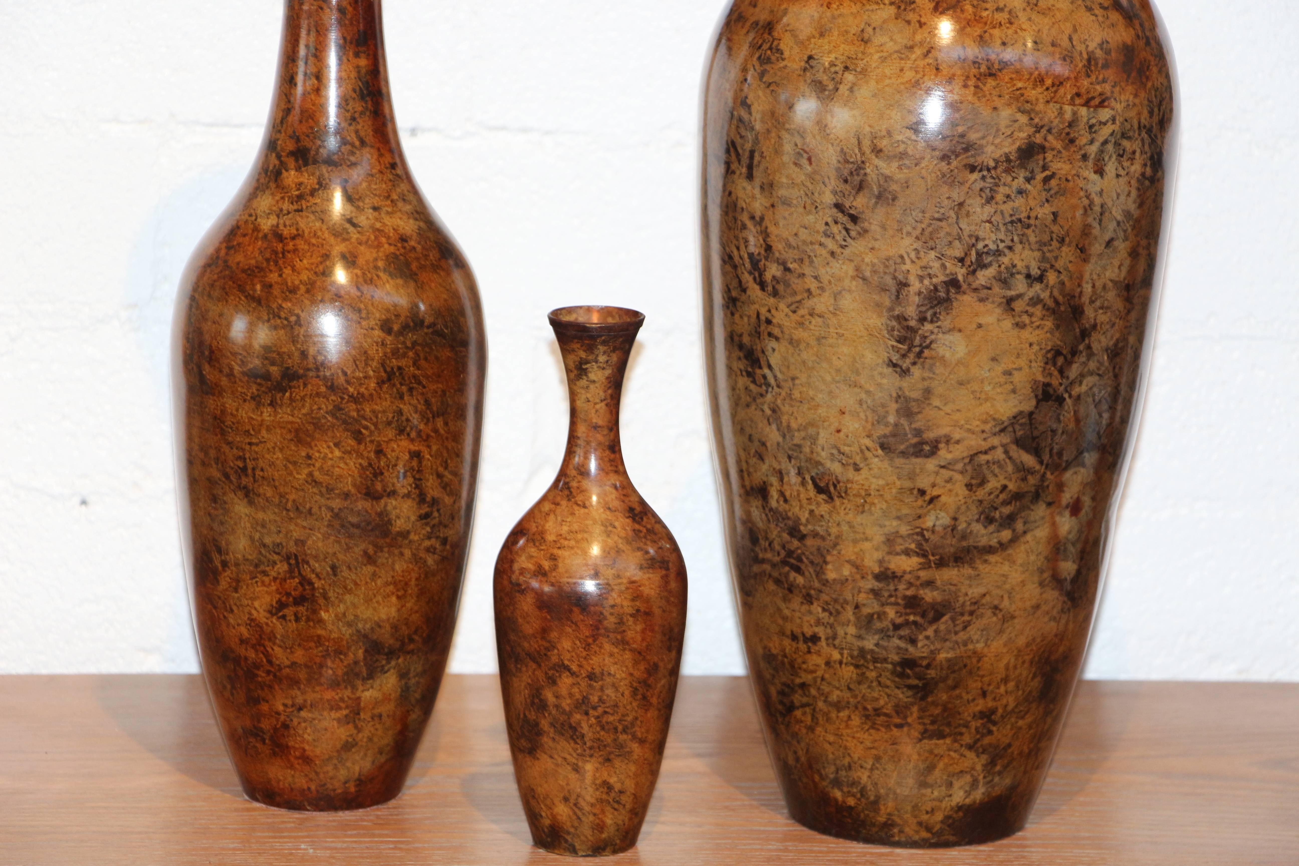 A nice set of three bronze tortoise patinated vases designed by Steve Chase. We are not sure who made them but they are great. Each rime has an added lip and each is scaled to the vase height. The tallest vase is 30 inches tall with a 9 inch