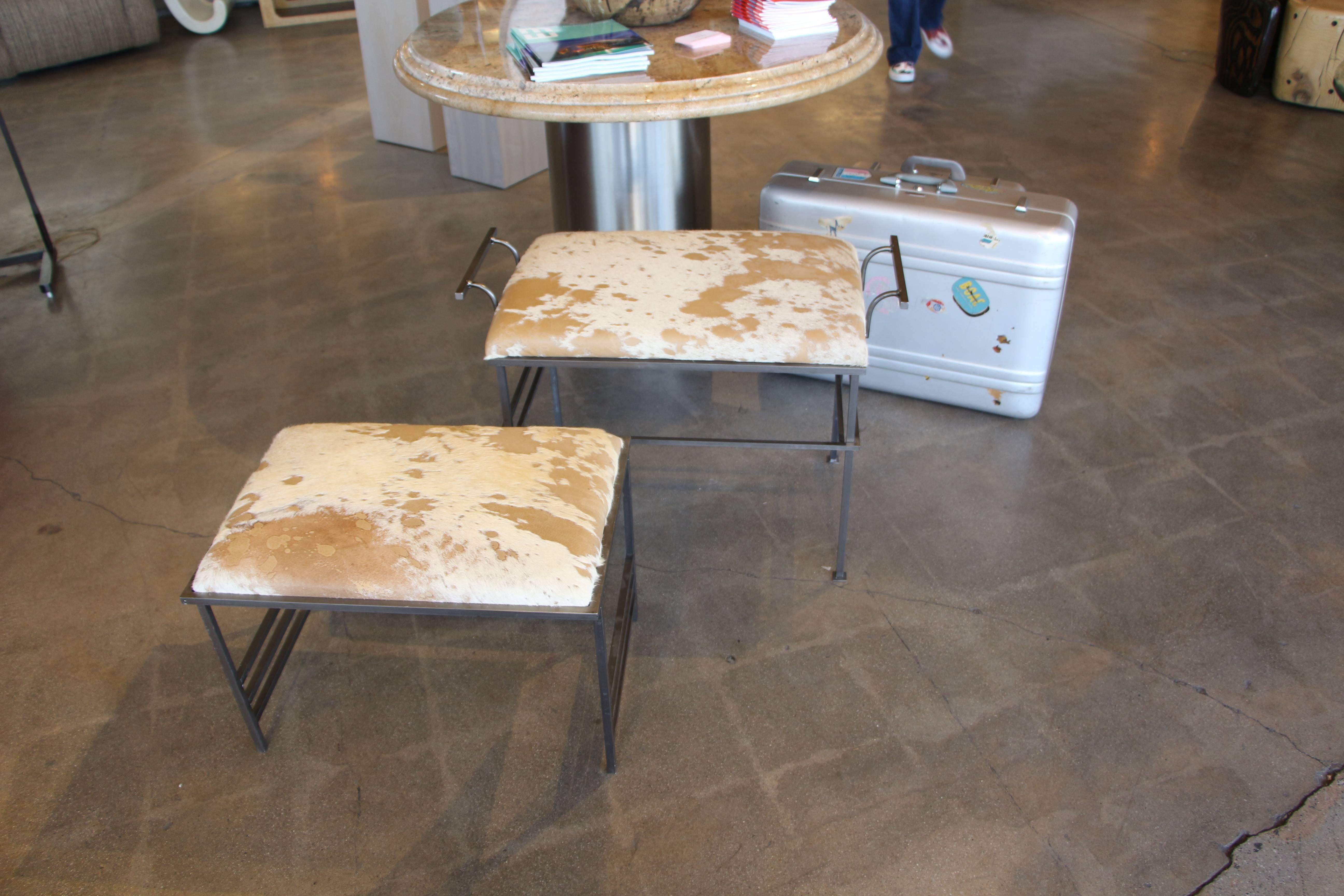 A nice matched pair of benches with Debrided Italian hides. These are probably handmade pieces, from viewing the from the weld marks. Both are extremely sturdy. The large one with the handles is 29