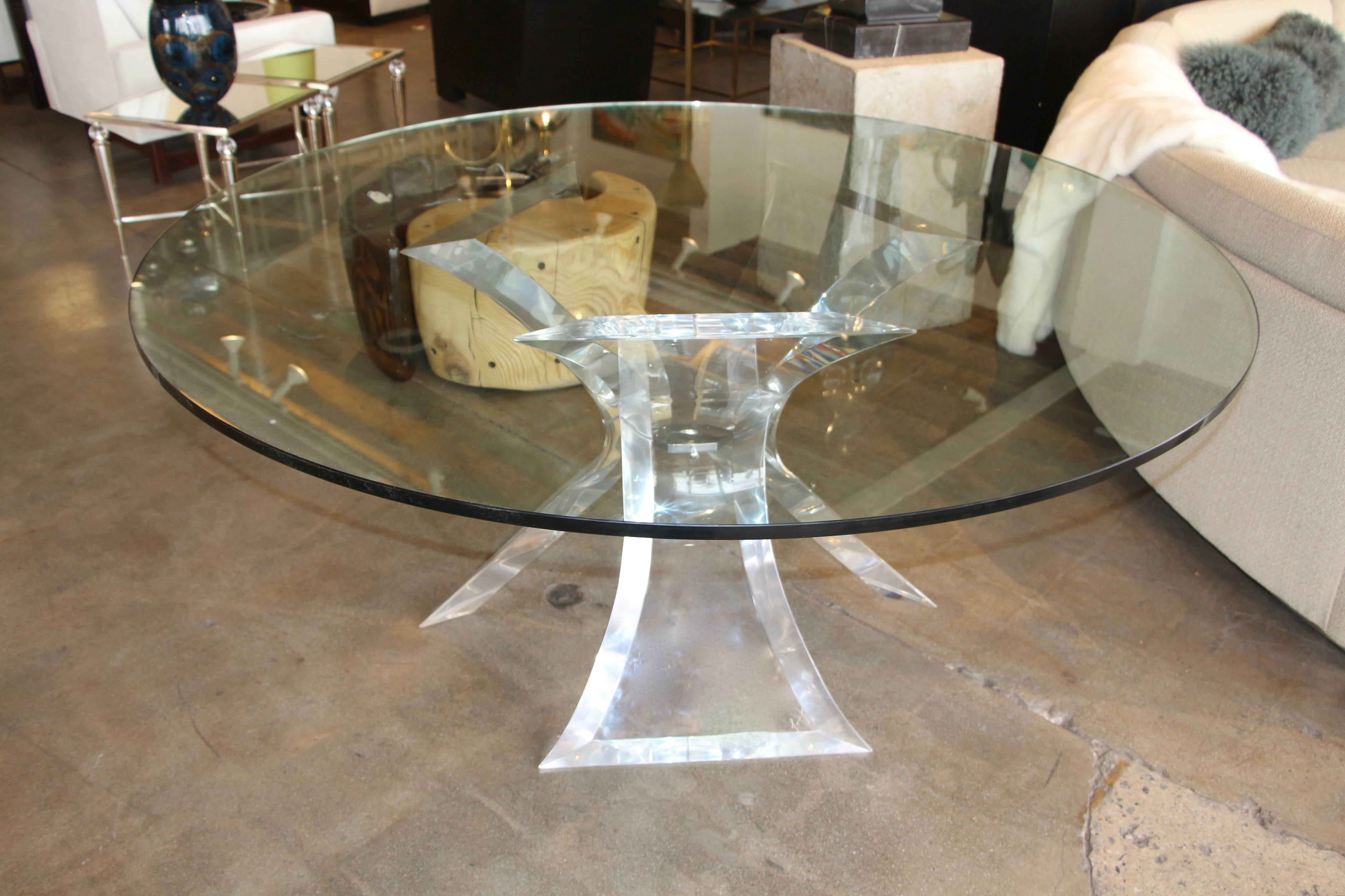 An unusual dining table with a triple base. Most of the triple base tables were coffee table height. The dining tables are usually two-piece butterfly bottoms. These thick Lucite pieces have been polished to a nice sheen. Most of the scratches have