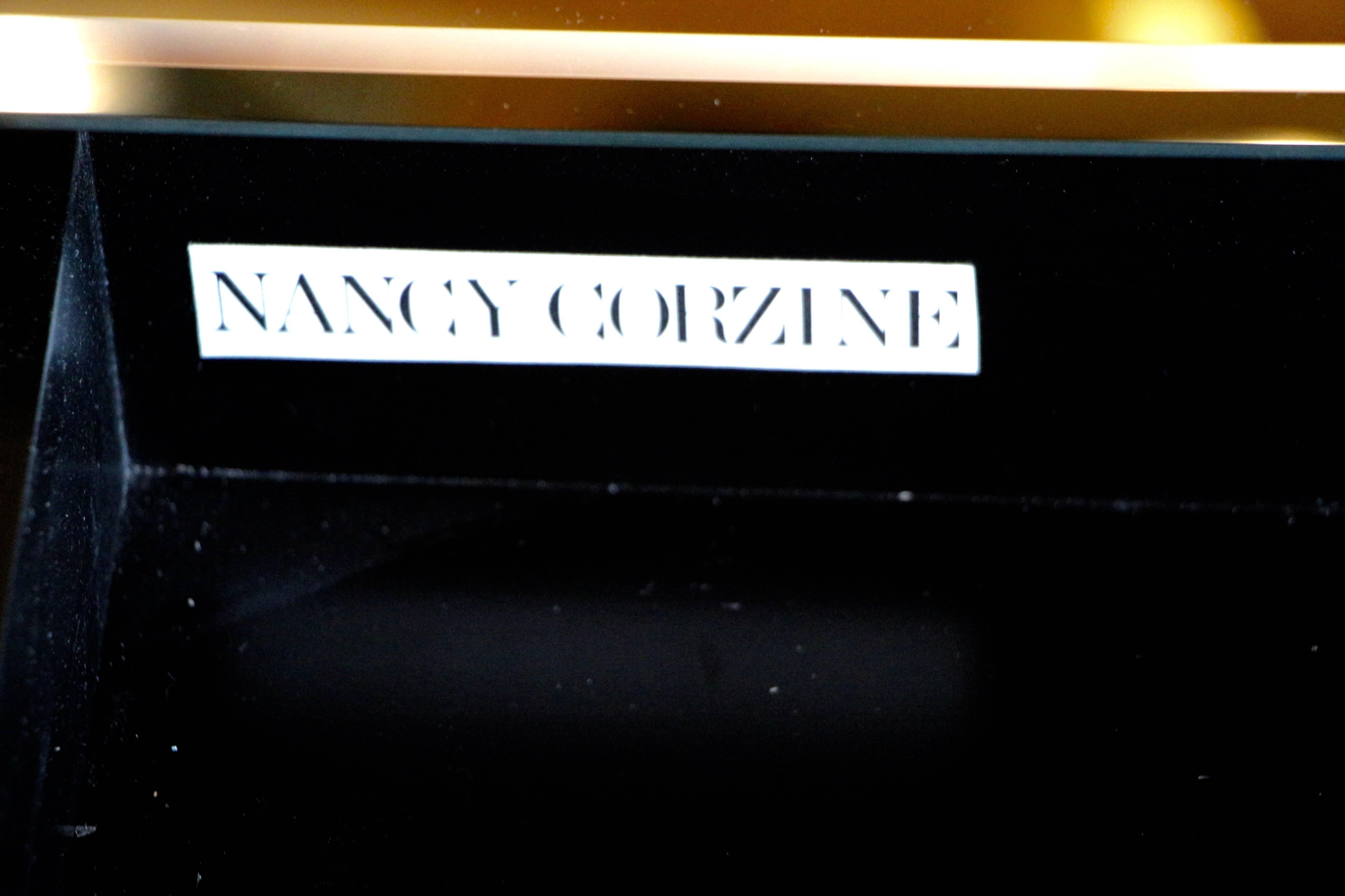 A custom-made mirrored desk designed and produced by Nancy Corzine. It bears a Corzine label. In beautiful condition with minor scratches and handling marks. There are no breaks to the mirror that we can find. There are two pieces of mirror on one