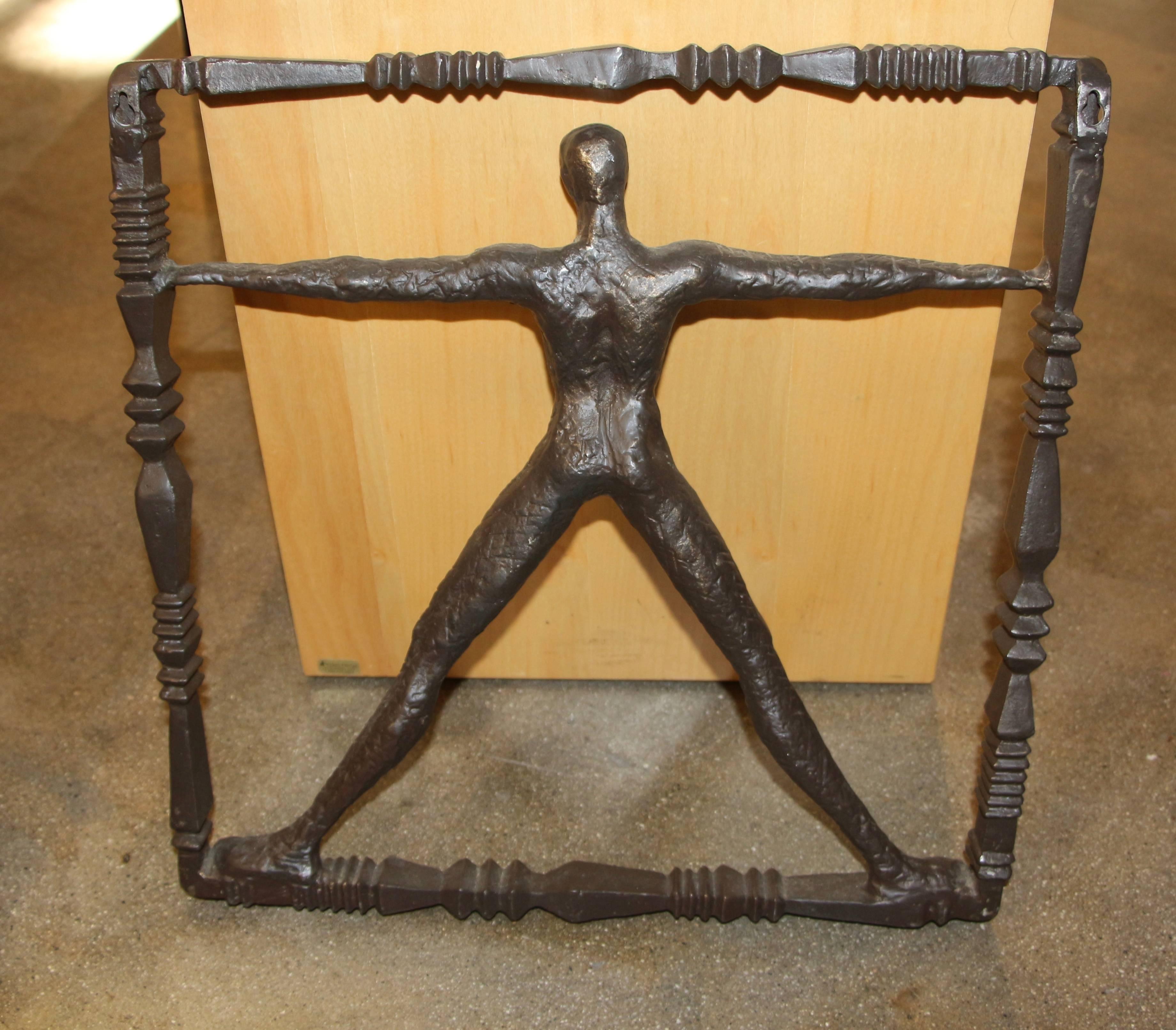 A nice sculpture of a man in a frame done in iron with a bronze patina. It is very much in the manner of Ernst Trova. This one is not signed that I can find. There are two hangers on the back top.
 