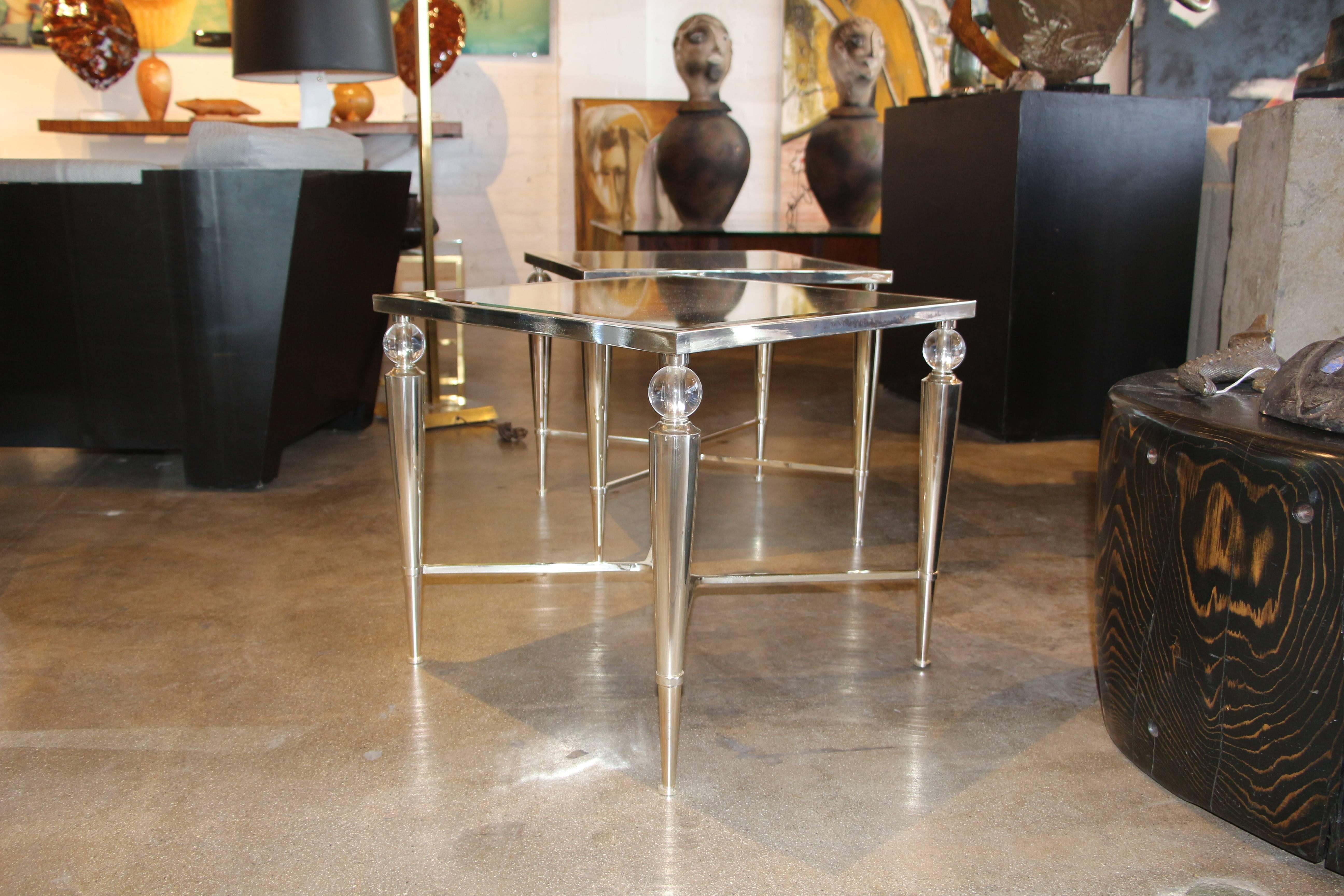Two elegant silvered mirror top accent or side tables. The glass ball supports are a nice feature. Nicely made and of high quality. There are scratches to the mirror tops and the metal bases, pictured.