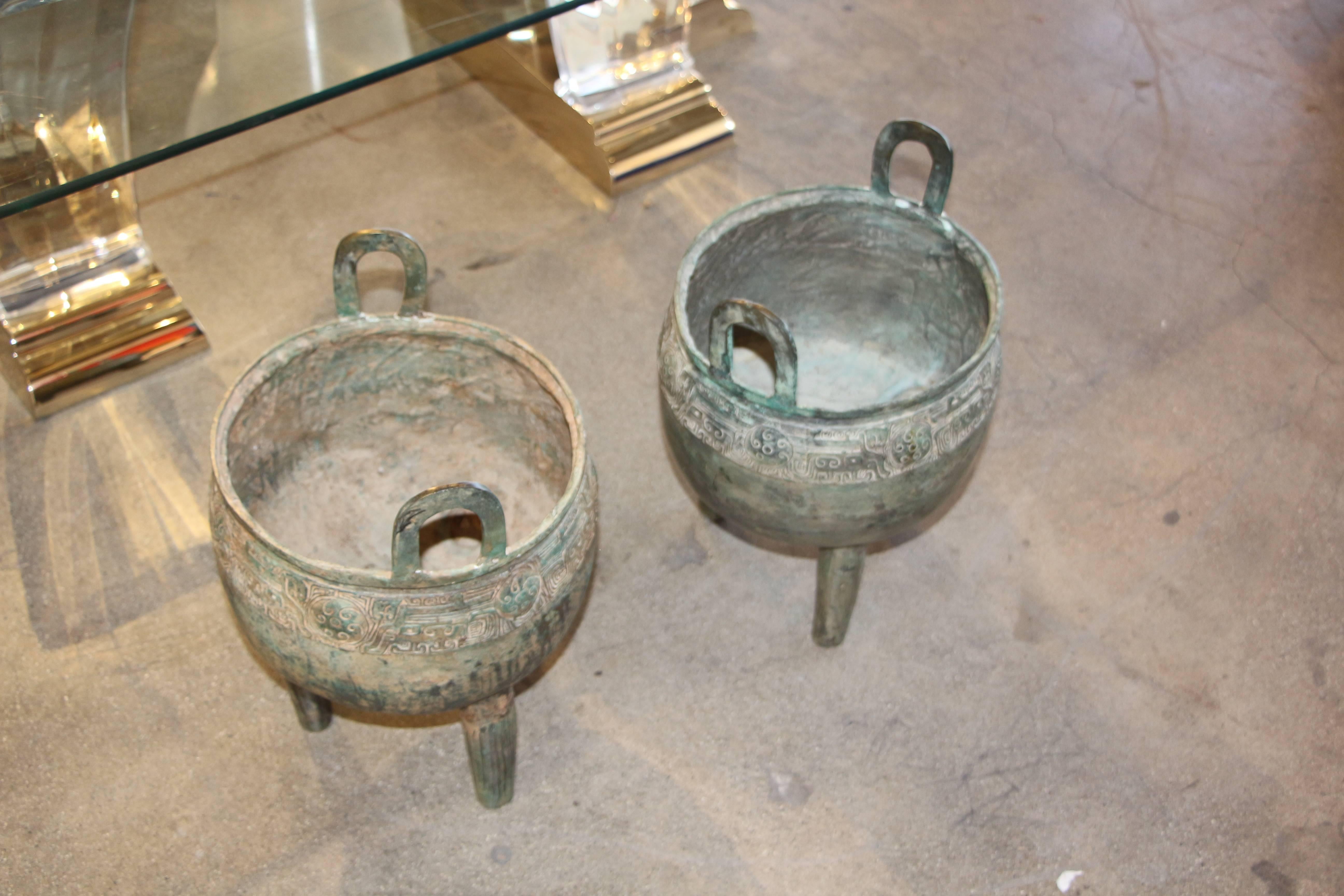 Pair Chinese Bronze Censers Circa 1900. Very well-made with hollow legs that required felt pads on the tripod legs. They are extremely elegant with great patina. Wear to the bodies and nicks, scratches and marks with age appropriate wear.