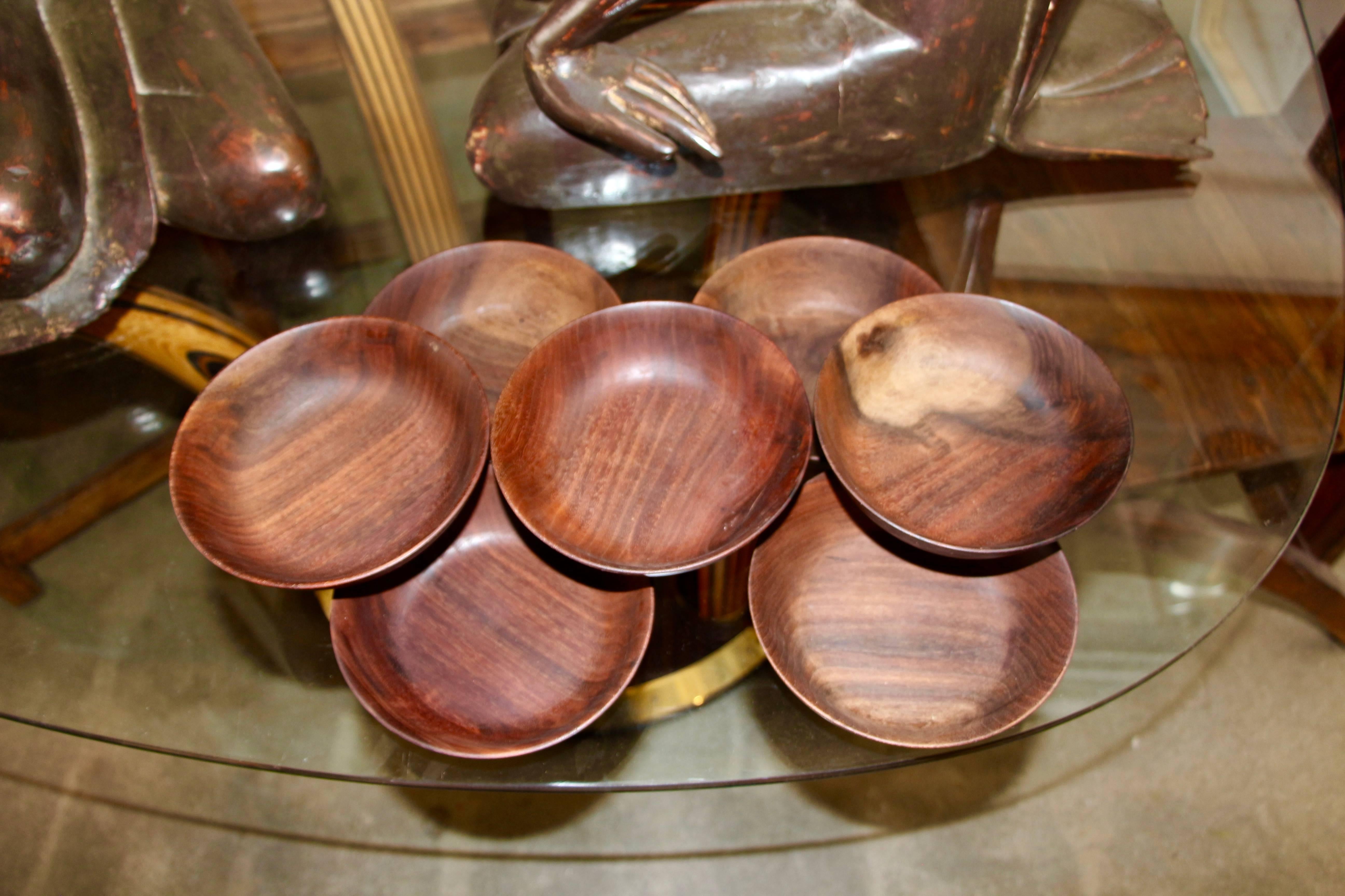 A nice set of seven black walnut hand-turned bowls by the noted Californian woodworker Bob Stocksdale. They are in good age appropriate condition with minor nicks, marks and losses.