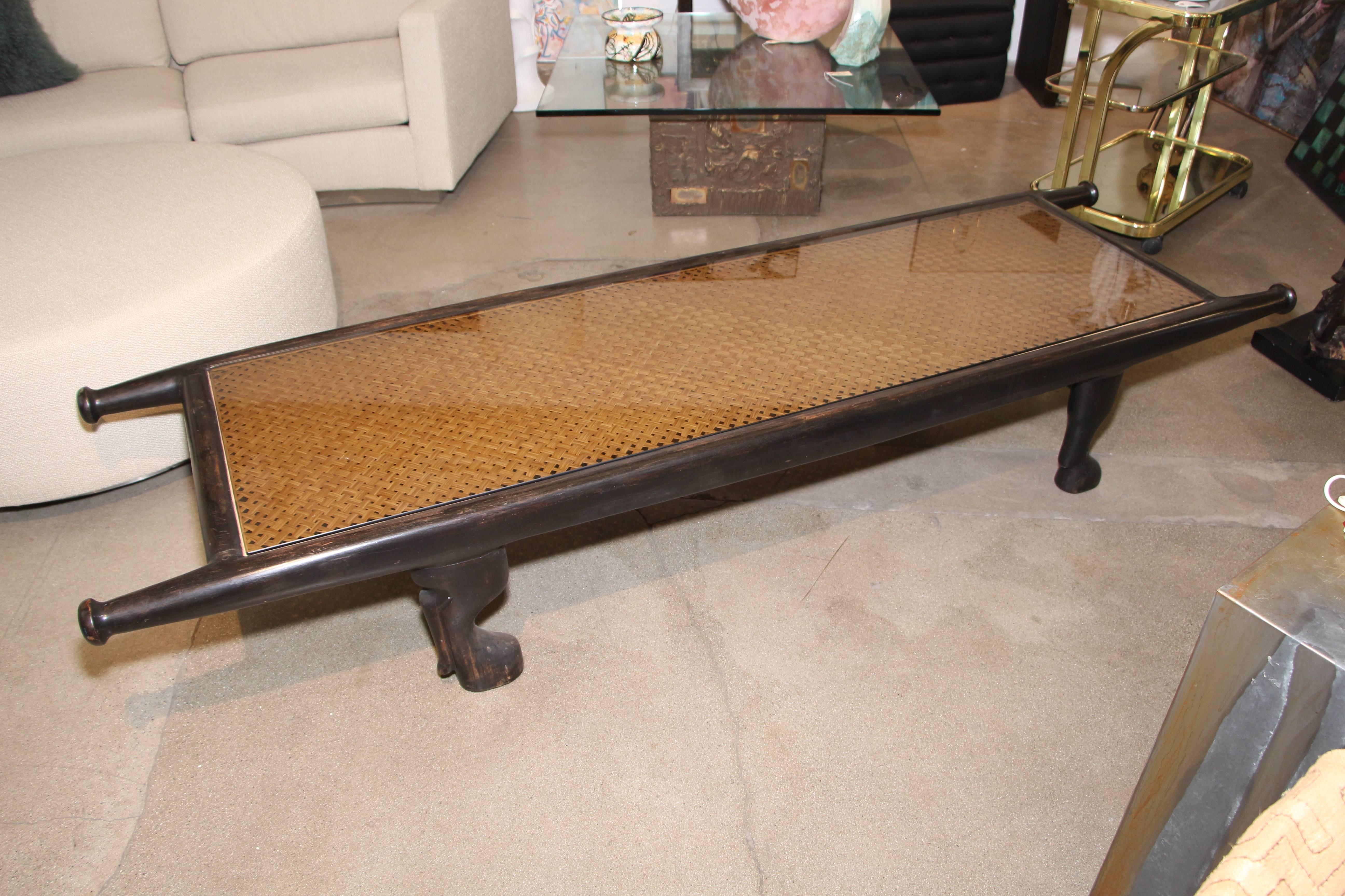 A nice early 19th-20th century carved caned bench or table. It could have been some sort of Campaign piece that was meant to be carried around hence the handles for carrying. The glass is modern to protect the caning. The piece are dowelled