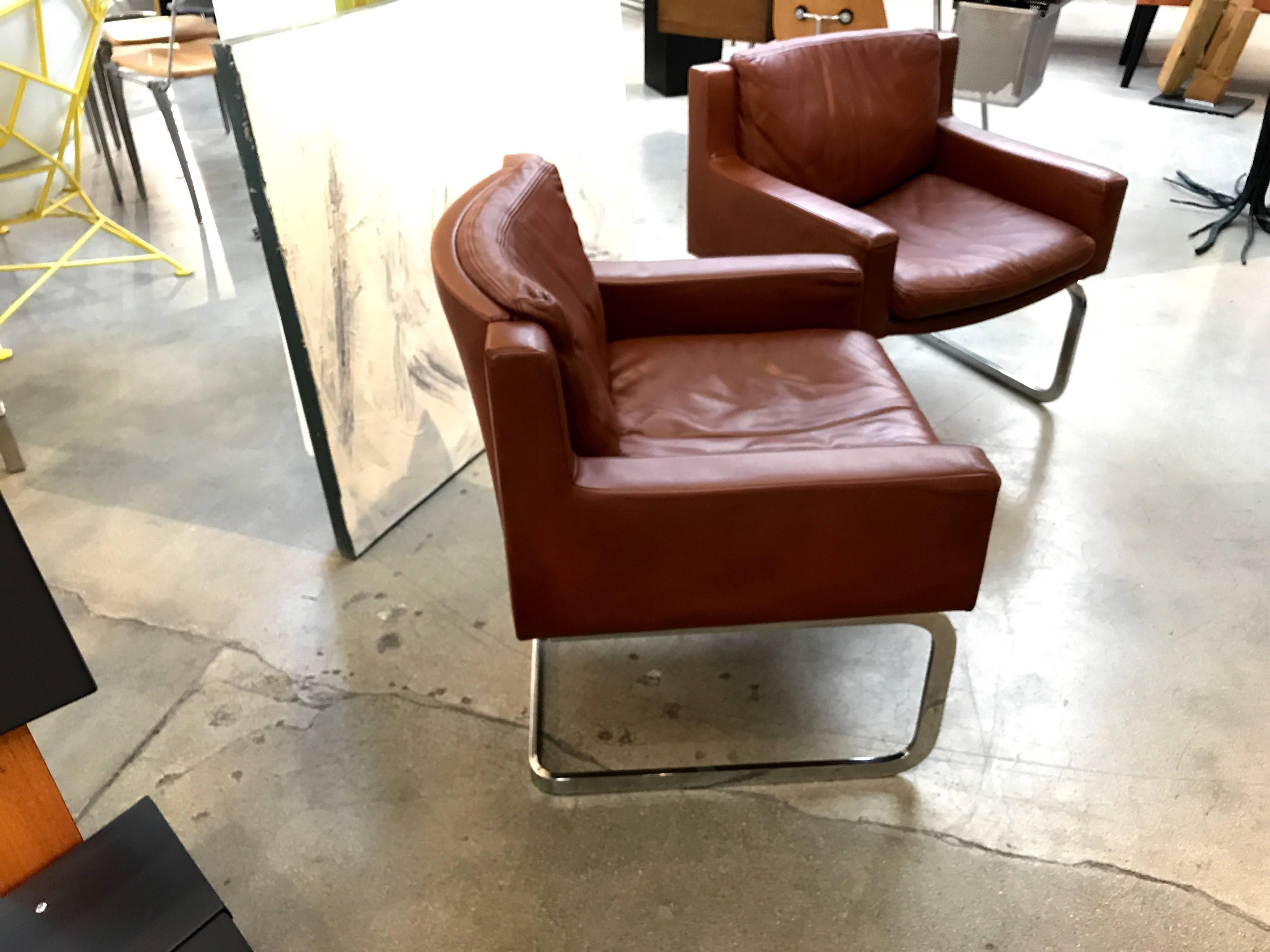 An elegant pair of lounge chairs designed by Robert Haussmann in 1957 for the venerable leather furniture company De Sede of Switzerland. These chairs are marked with the De Sede Exclusive logo on the underside of the cushions. We believe these