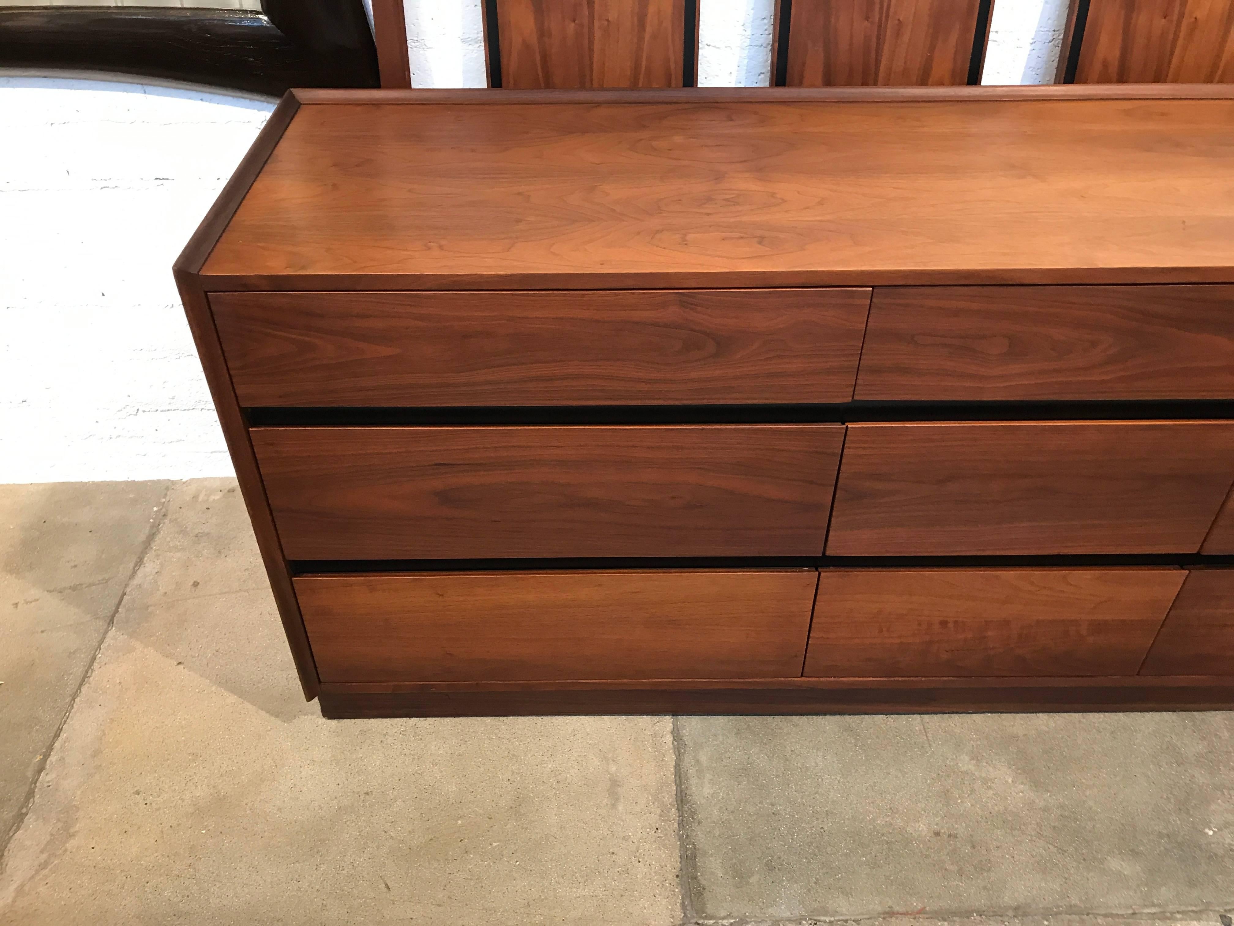 A nice nine-drawer walnut dresser by Dillingham in good age appropriate condition. Labeled as well. There are some marks and surface scratches but in good age appropriate condition.