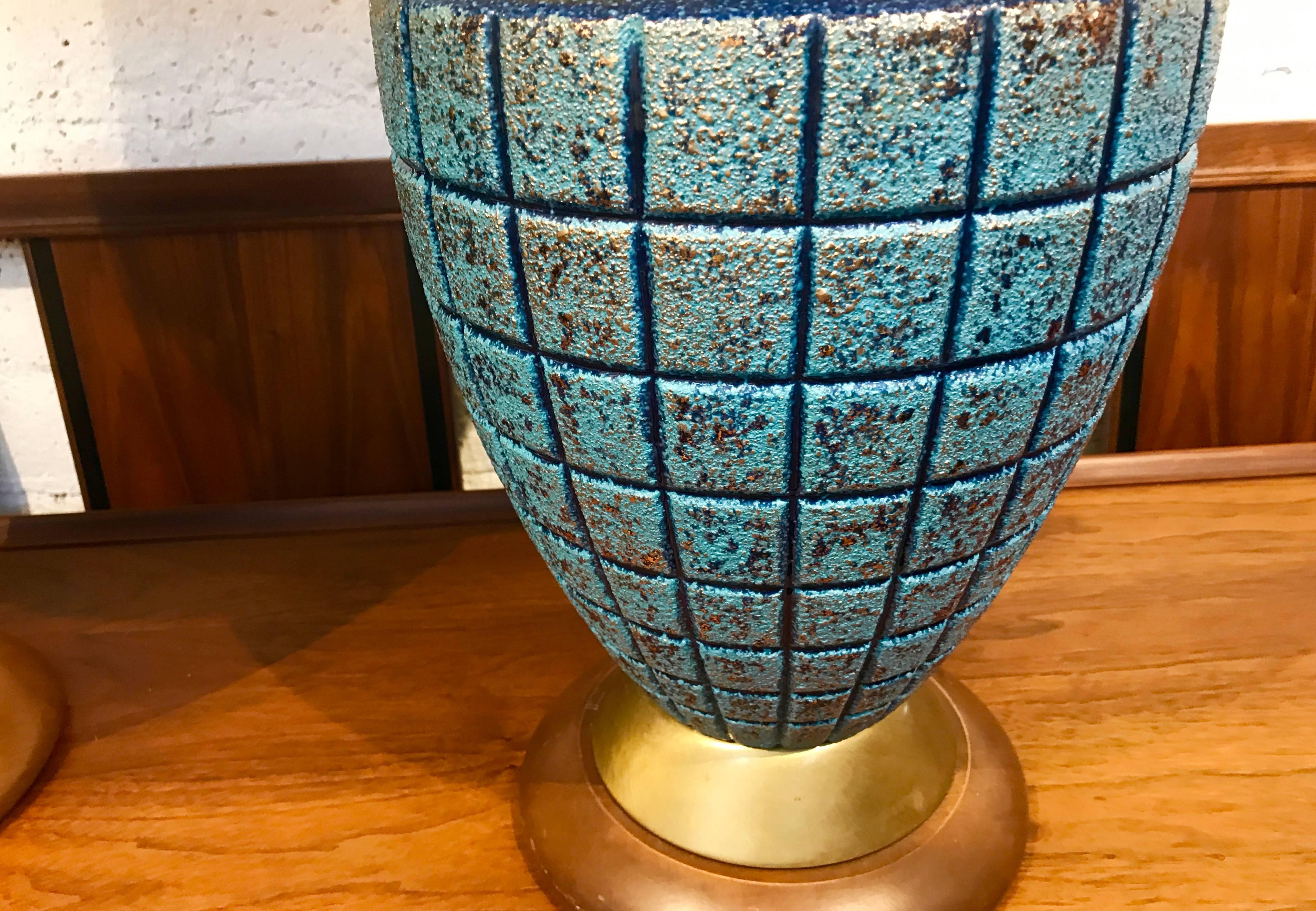 A nice 1960s pair of Ceramic lamps in nice age appropriate condition, with their original shades trimmed blue piping. These lamps have been rewired and are ready to go. The wood bases have some scuff marks and minor nicks. The shades are in good age