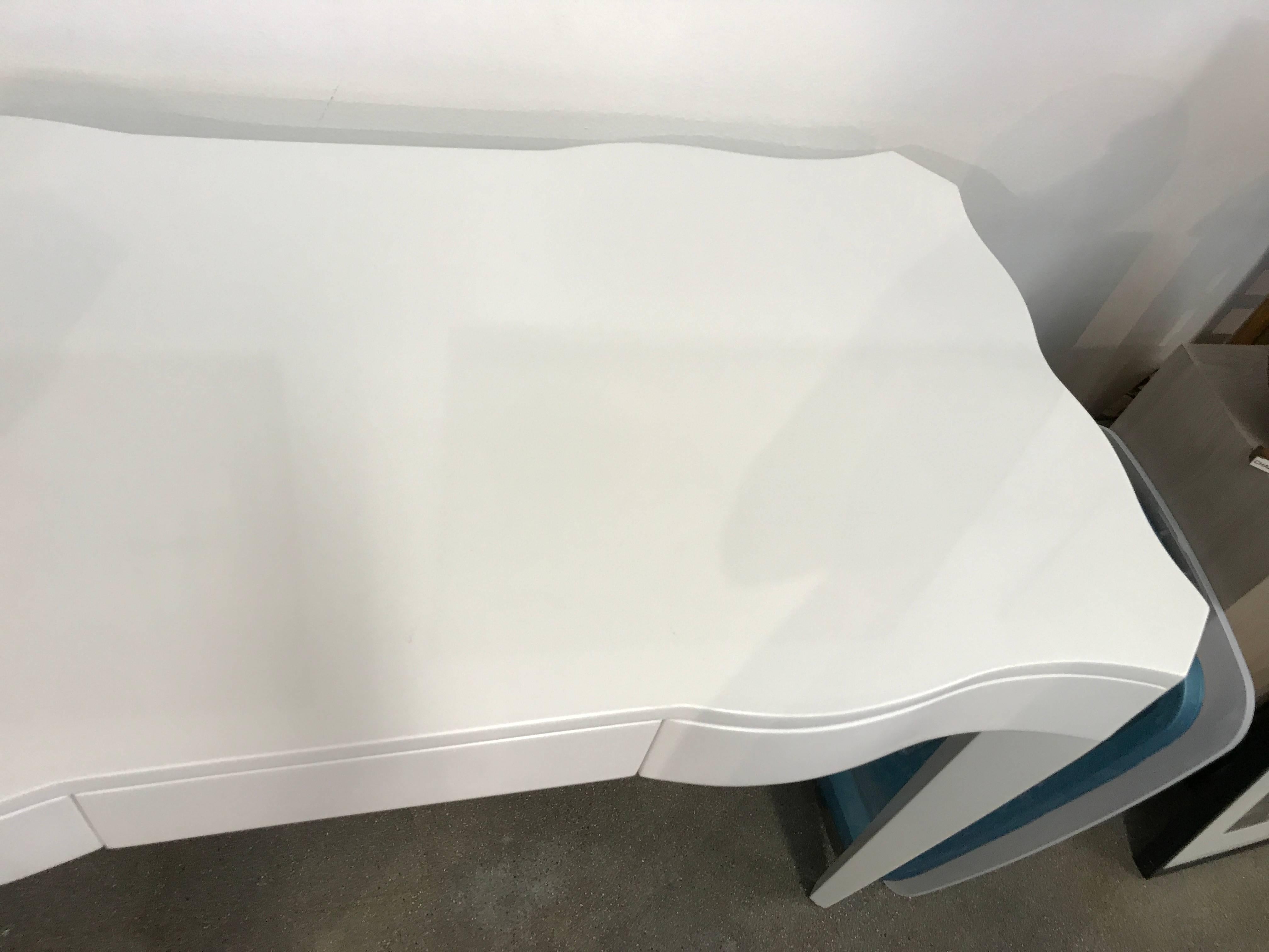 A nice vanity or small desk by Nancy Corzine in a white lacquer finish. Minor handling marks, in good condition, probably a showroom piece.
Each drawer has Nancy Corzine burnt into the wood.