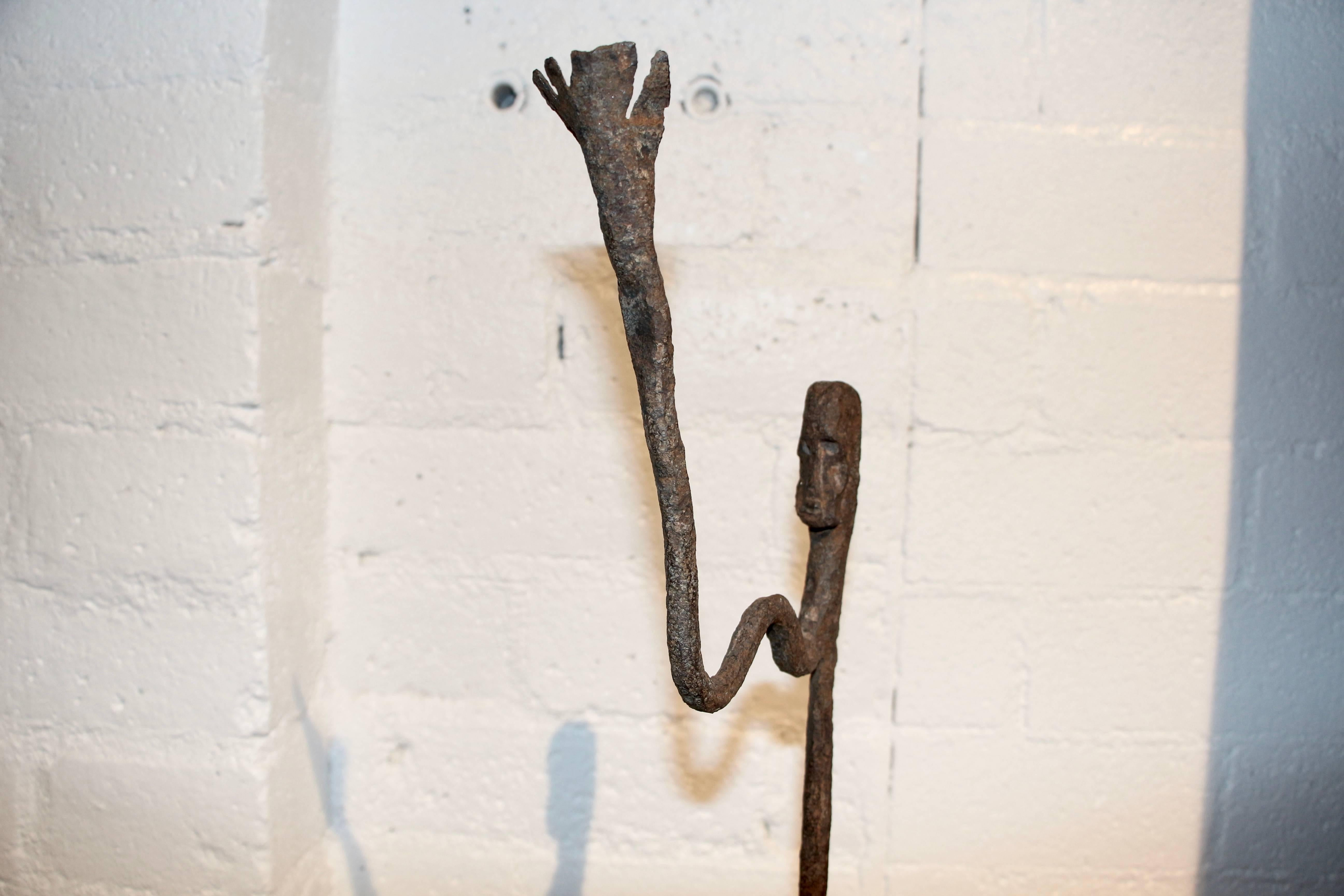 A nice mounted figural altar staff from the Dogon tribe of Mali. Mounted in an iron holder on a wood base. The staff is rusted and the wood painted base has some losses.
These were acquired from a collection from a private collection in Amsterdam,