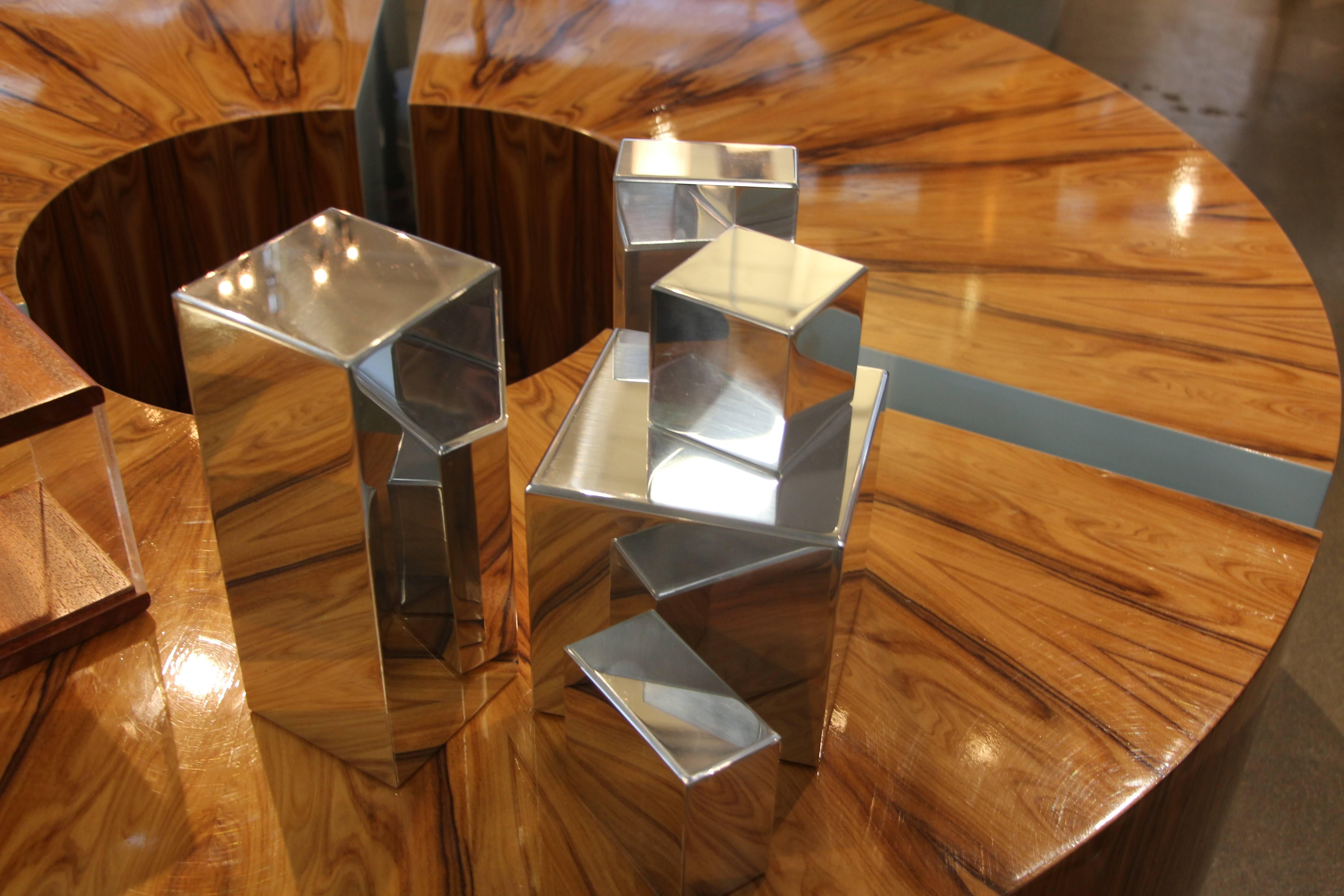 Our gallery is proud to represent an new talented artist Casey Cross who now resides in Palm Springs, CA. His work is unique and quite unusual. These geometric shapes can be arranged in any way. They are polished aluminum shapes. Each piece has been