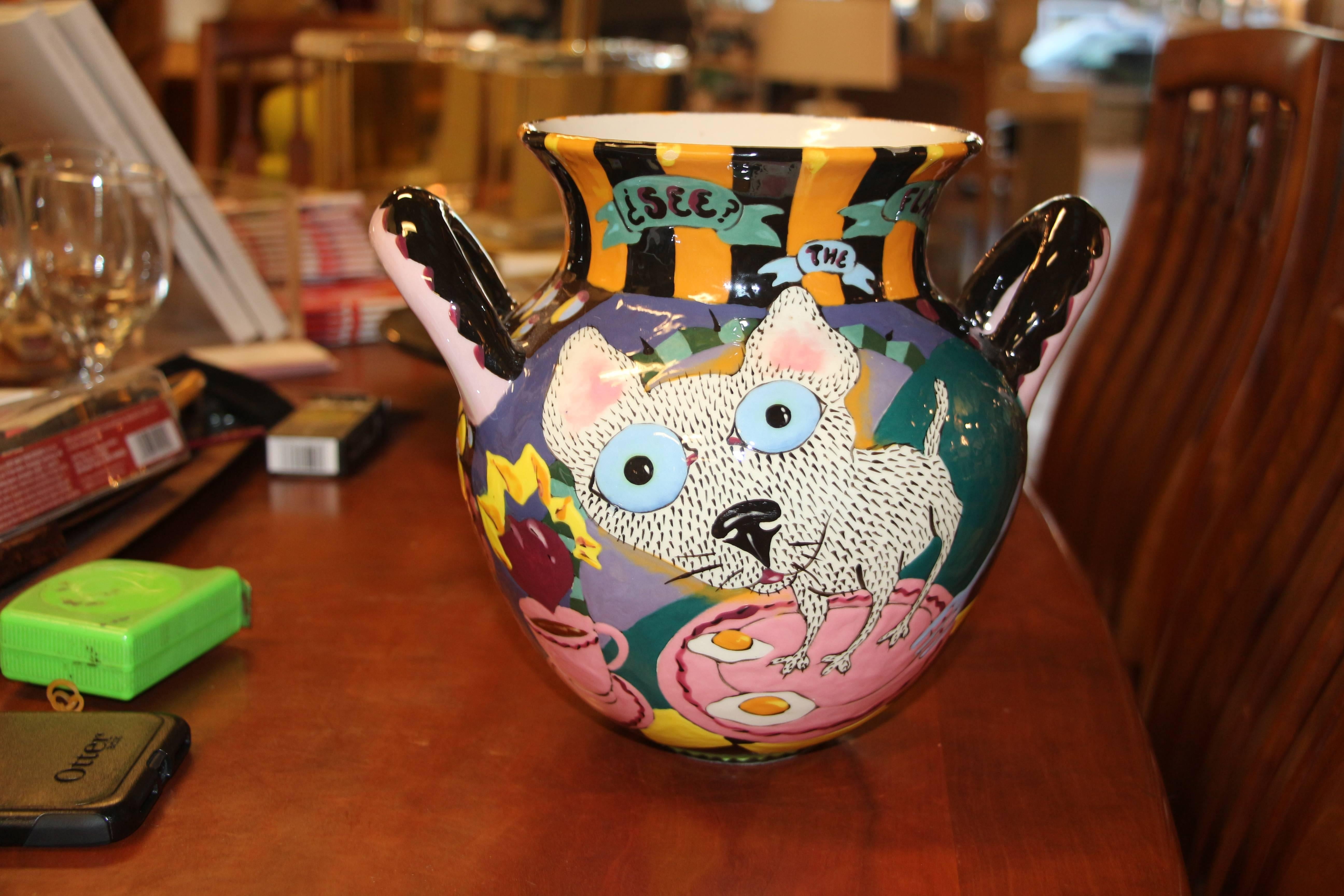 A whimsical Glazed hand done pot featuring a chihuahua or perhaps a cat on a pan with eggs on one side and jumping up in alarm on the other side. It reads on one side, see the flames and on the other Oh!. Signed on the base David Gurney 1989. There