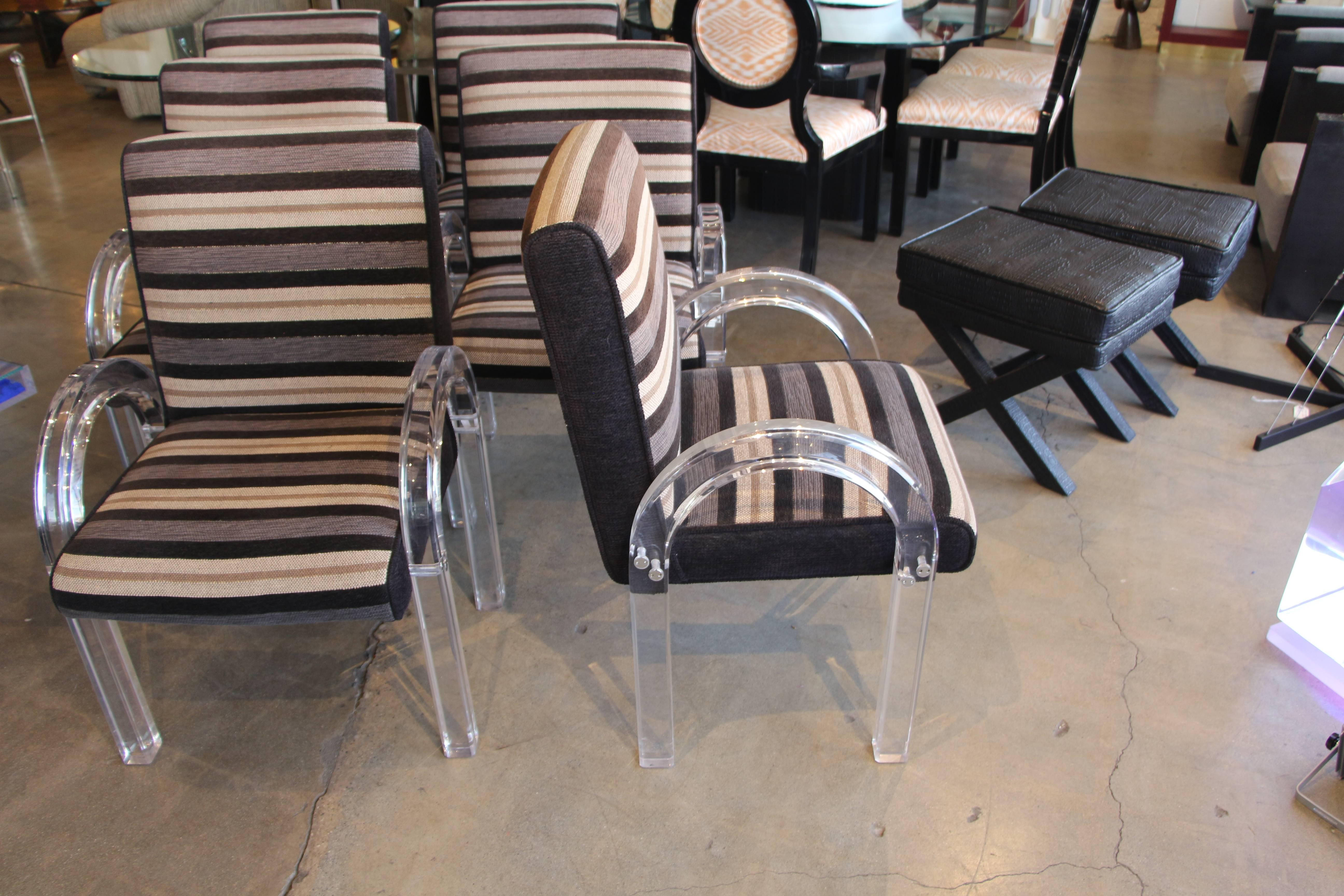 A nicely upholstered set of six dining chairs designed by the acrylic master Charles Hollis Jones. These chairs are upholstered in a rich striped fabric with a gold lurex thread through the striped.
Some of the fabric looks a little lighter in