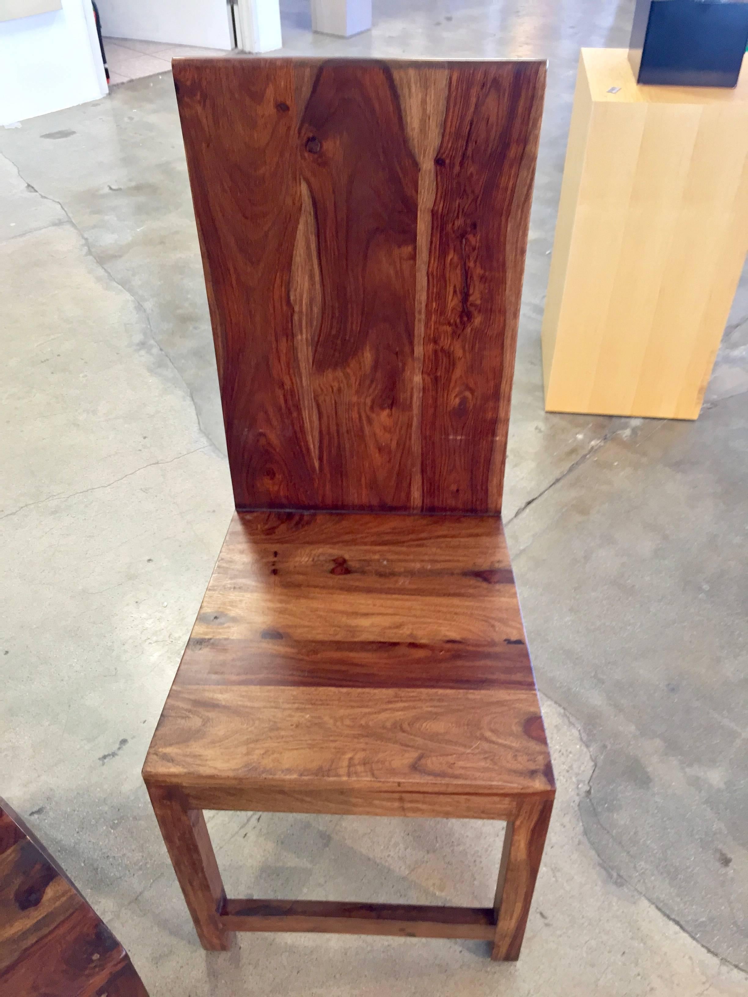 A set of four incredibly figured handmade chairs. The graining and figuring on each is unique and striking. These are most likely an exotic wood from the west pacific. As each chair is handmade, they are all slightly different in dimension and