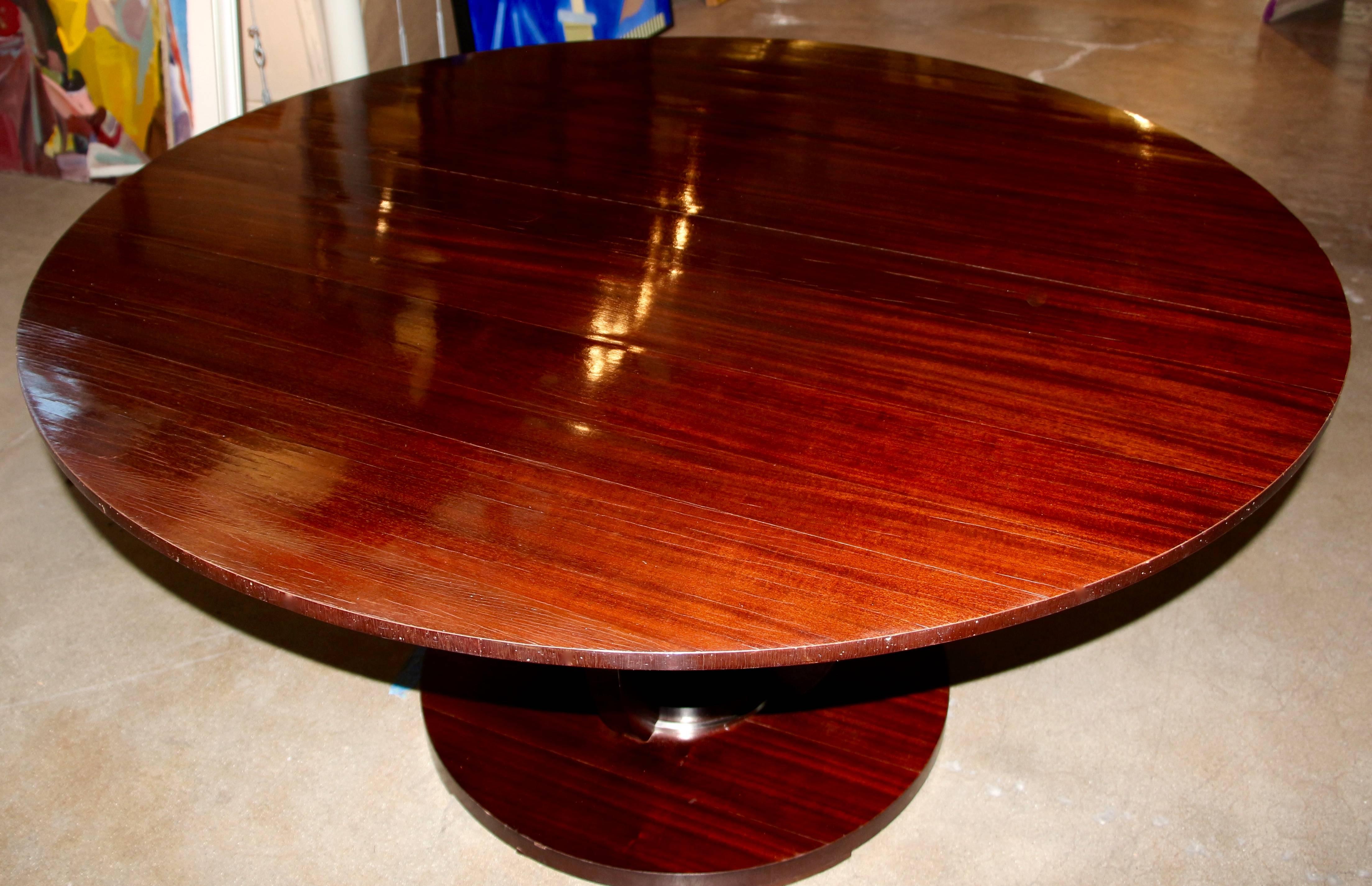 A nice Barbara Barry designed table for Baker Furniture. It features her signature raised mahogany veneer strips, which add interest and texture to the top. Base features four supports, with Chrome or still accents on the base. Unfortunately on of