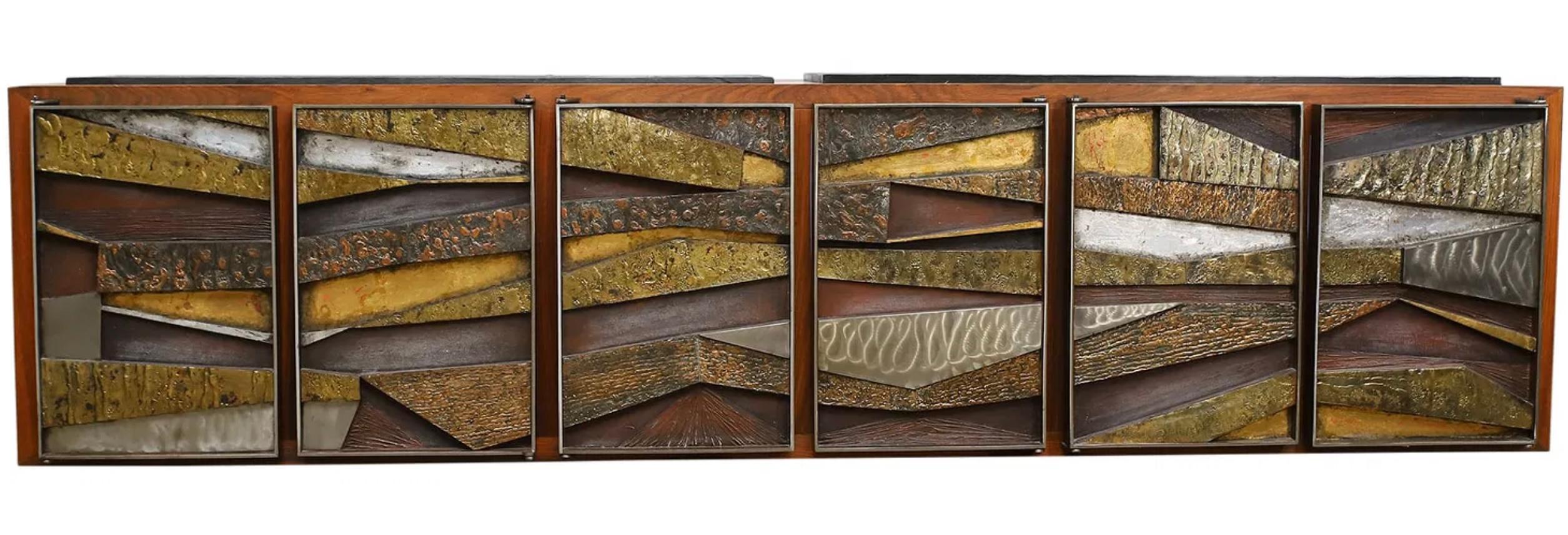 An incredible Brutalist floating sideboard cabinet by the noted Pennsylvania artist Murrie Gayman. This Studio piece is crafted out of walnut with inset slate slabs on top and doors of welded bronze, steel, iron and some other mixed metals. The