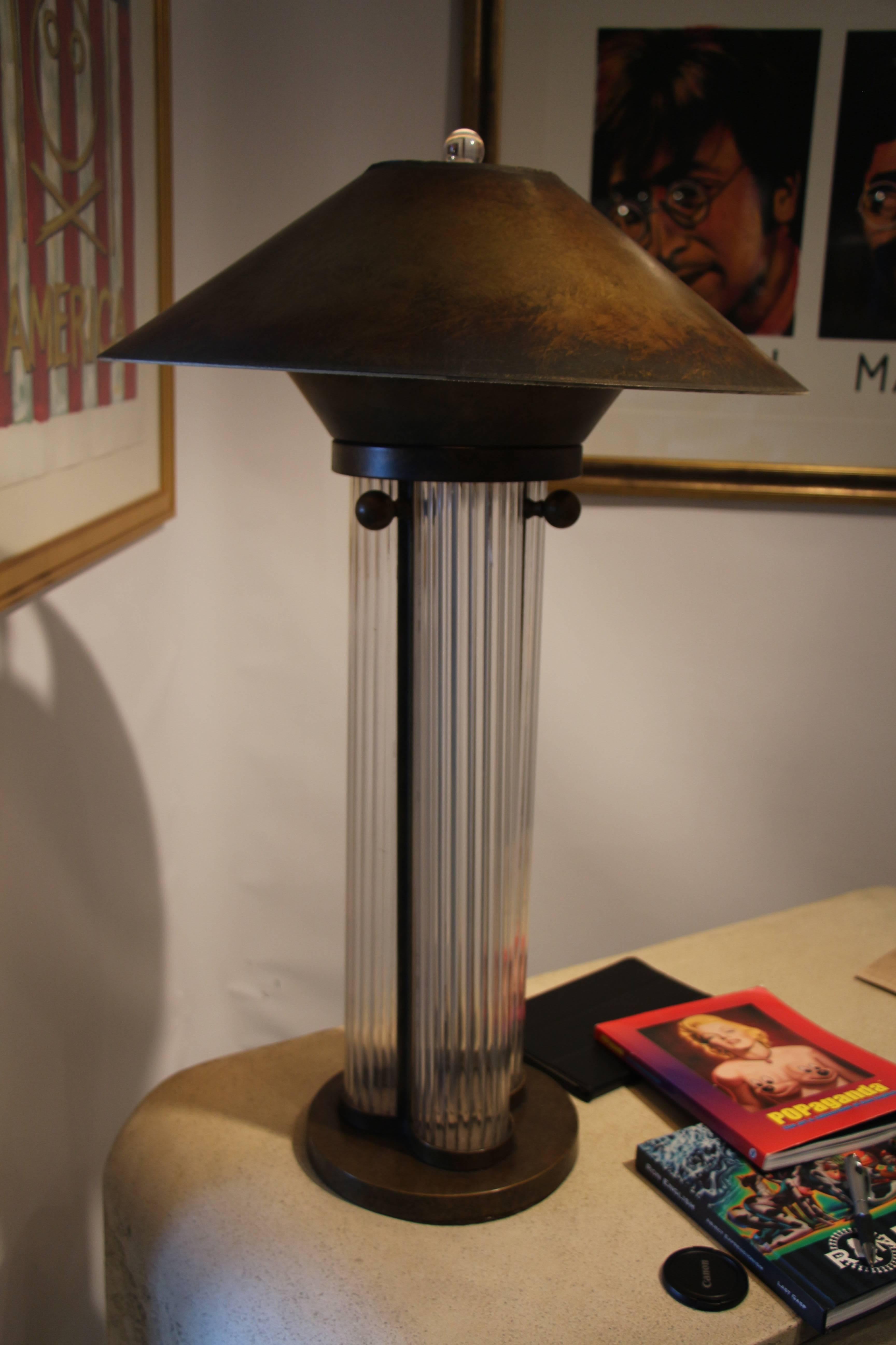 Out of a desert home is this lovely bronze patina lamp with a matching paper shade patina to match. Lamp is in working order. The is a slight crack near the top of one of the columns, but you must really look for it. Quite solid otherwise.
Diameter