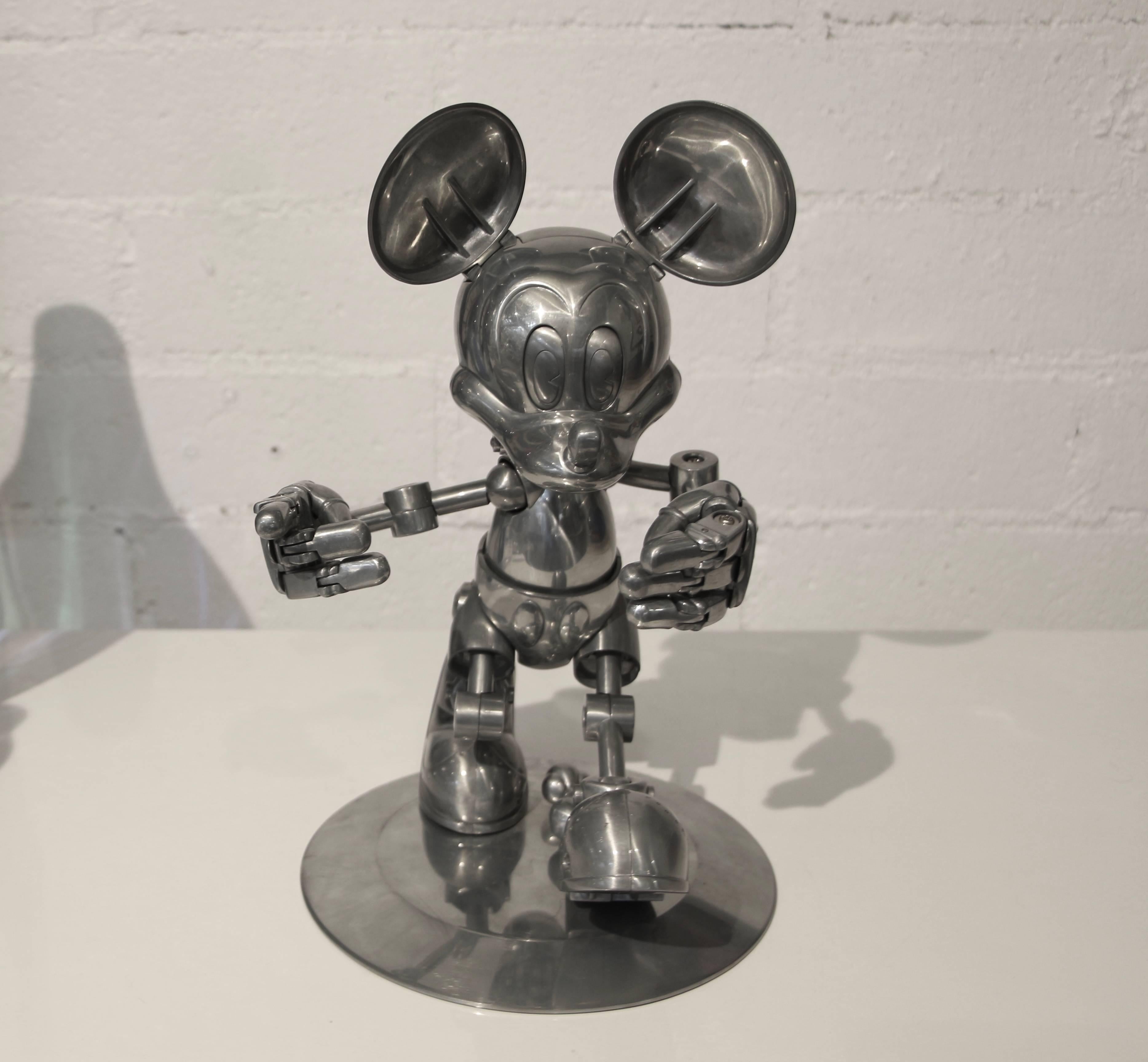 A fully articulated Future Mickey Mouse designed by Hajime Sorayama and made by the Tomy Toy Company in 2004. They only made 1000 of these and this one is numbered 991. His hand move and his eyelids even open and close. A great collectors piece. He