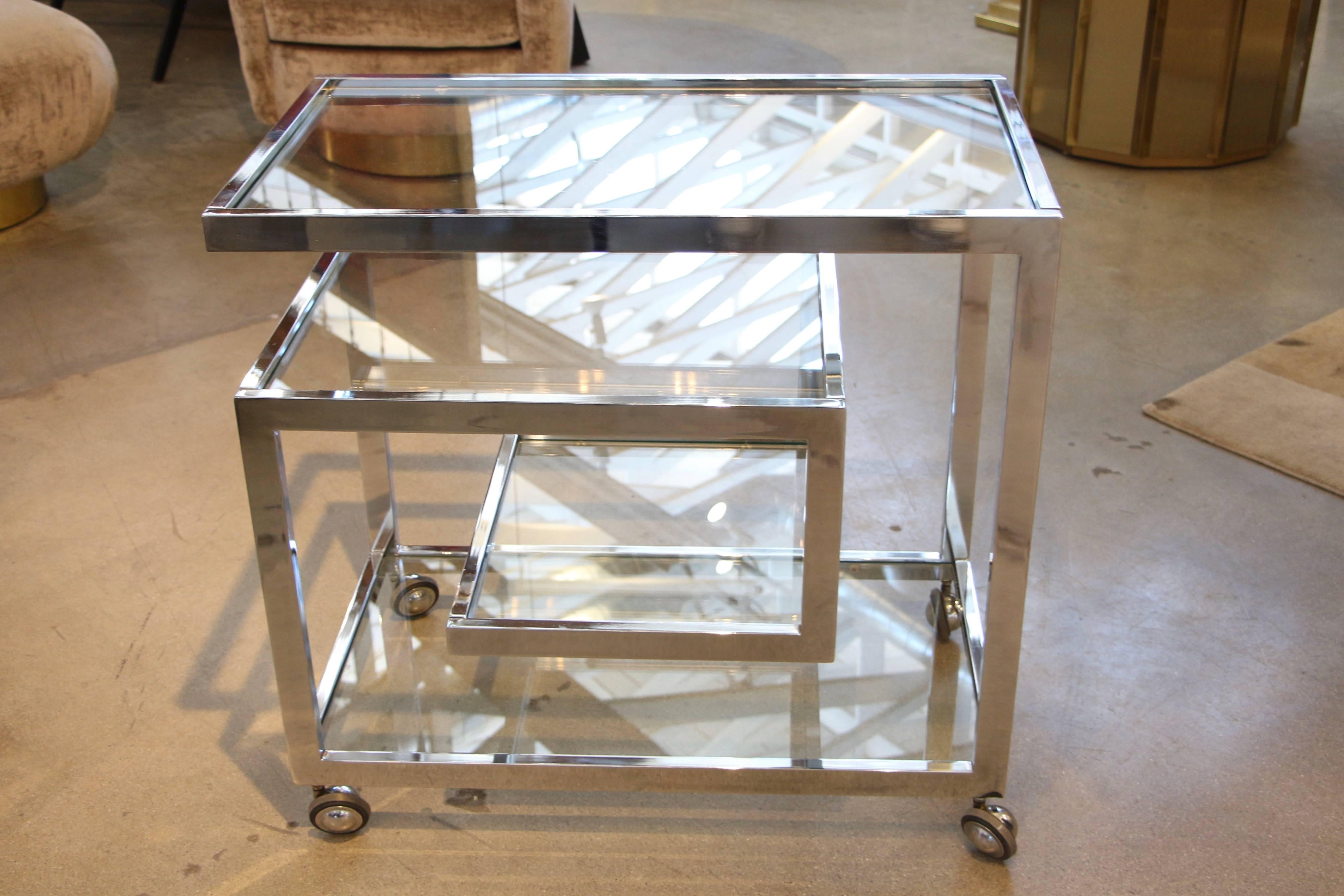 A beautiful Milo Baughman designed chrome bar cart on casters. A very elegant design in great condition for it's age.
