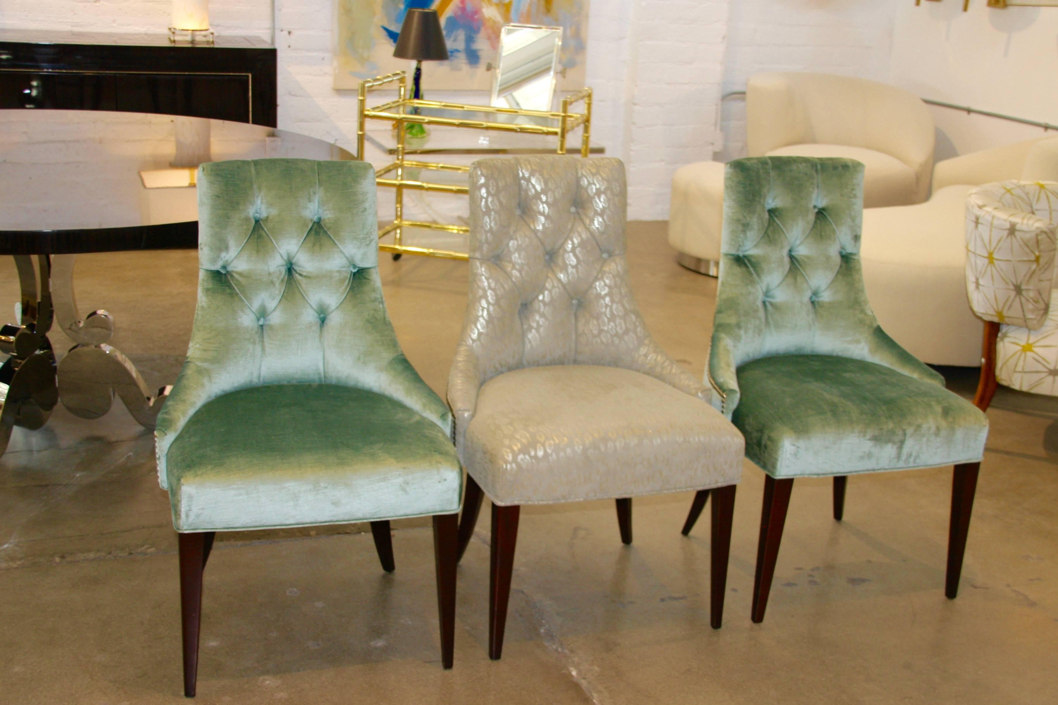 A lovely set of six Thomas Baker designed Ritz dining chairs by Baker Furniture. There three in one fabric and the other three are in a complementary fabric. They look great alternating around a table. They each feature a handle on the back.