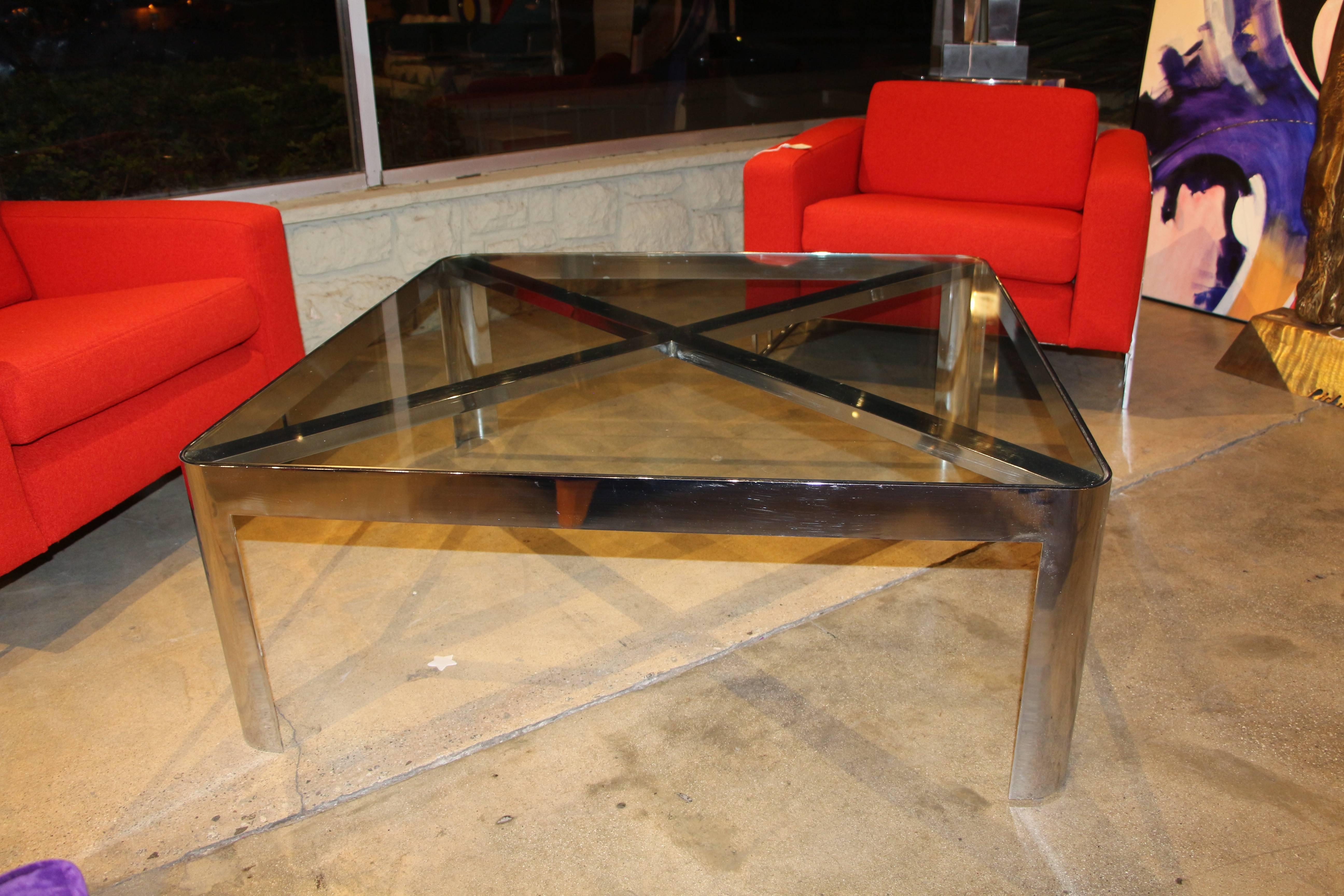 A most unusual chrome steel coffee table. This table is from a famous Palm Springs hotel that is currently being renovated. The glass has surface scratches from use but is original. The chrome has quite a few scratches from use and wear. Please see