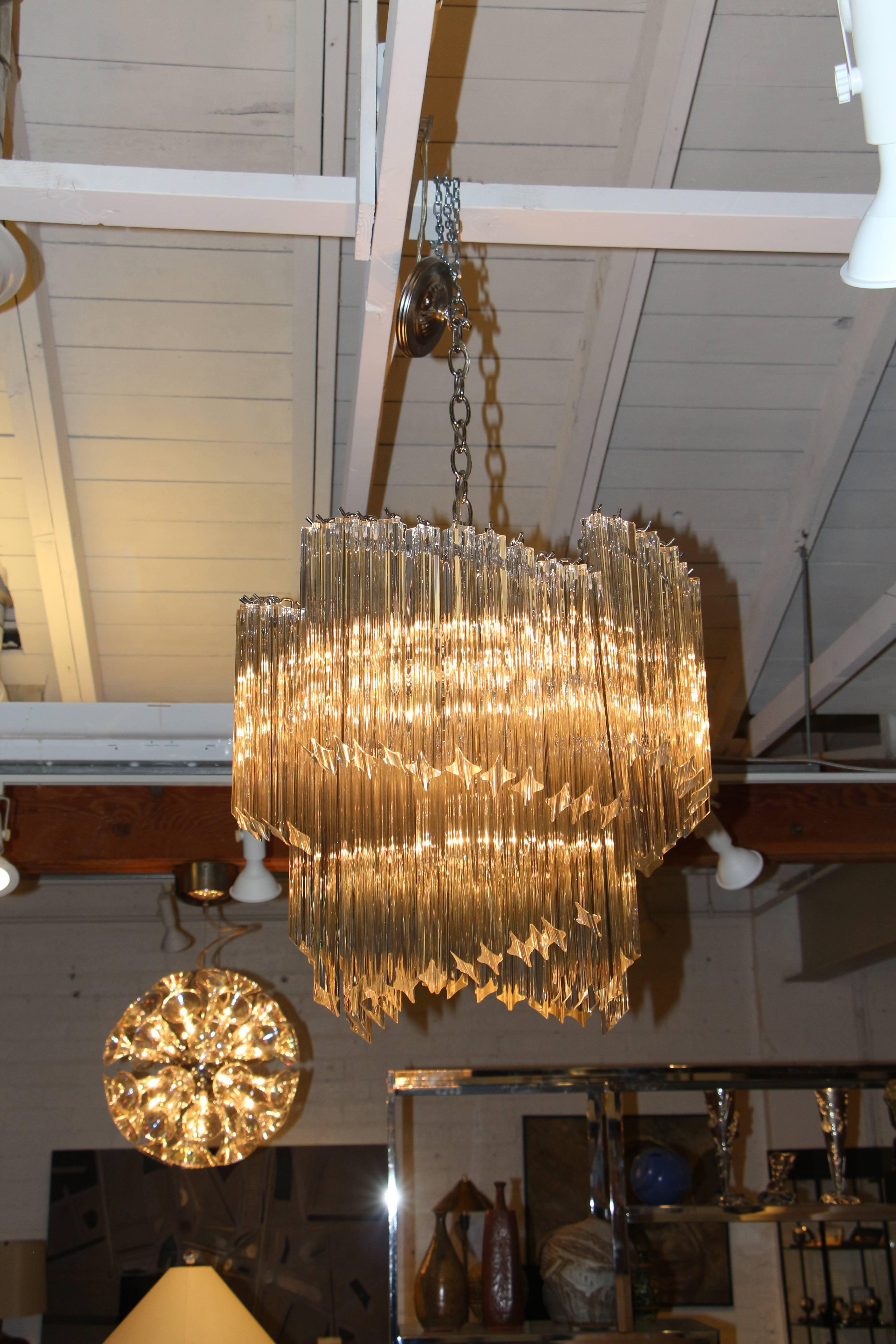 A beautiful Camer fixtures with Venini glass pendants. The crystals are approximate 11.5 inches long. The dimensions given are for the fixture itself, not including the chain. There are a number of chips to the crystals. Hard to see the flaws when
