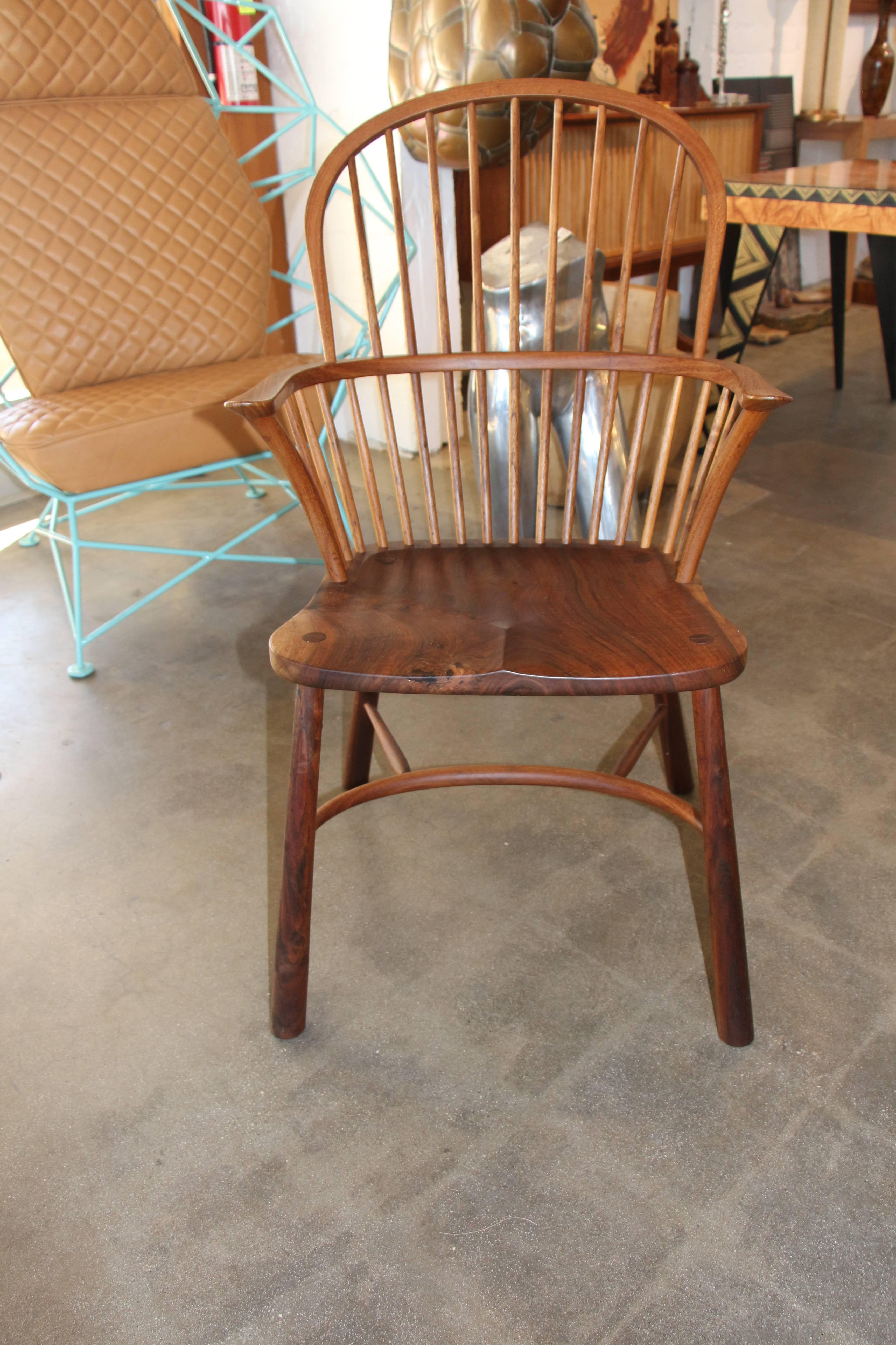A nice monogrammed black walnut chair. This is clearly the work of a talented craftsman, and has a very elegant feel to it. One arm has been repaired, which is pictured. The joints where the legs meet the seat have also been re-glued. There are
