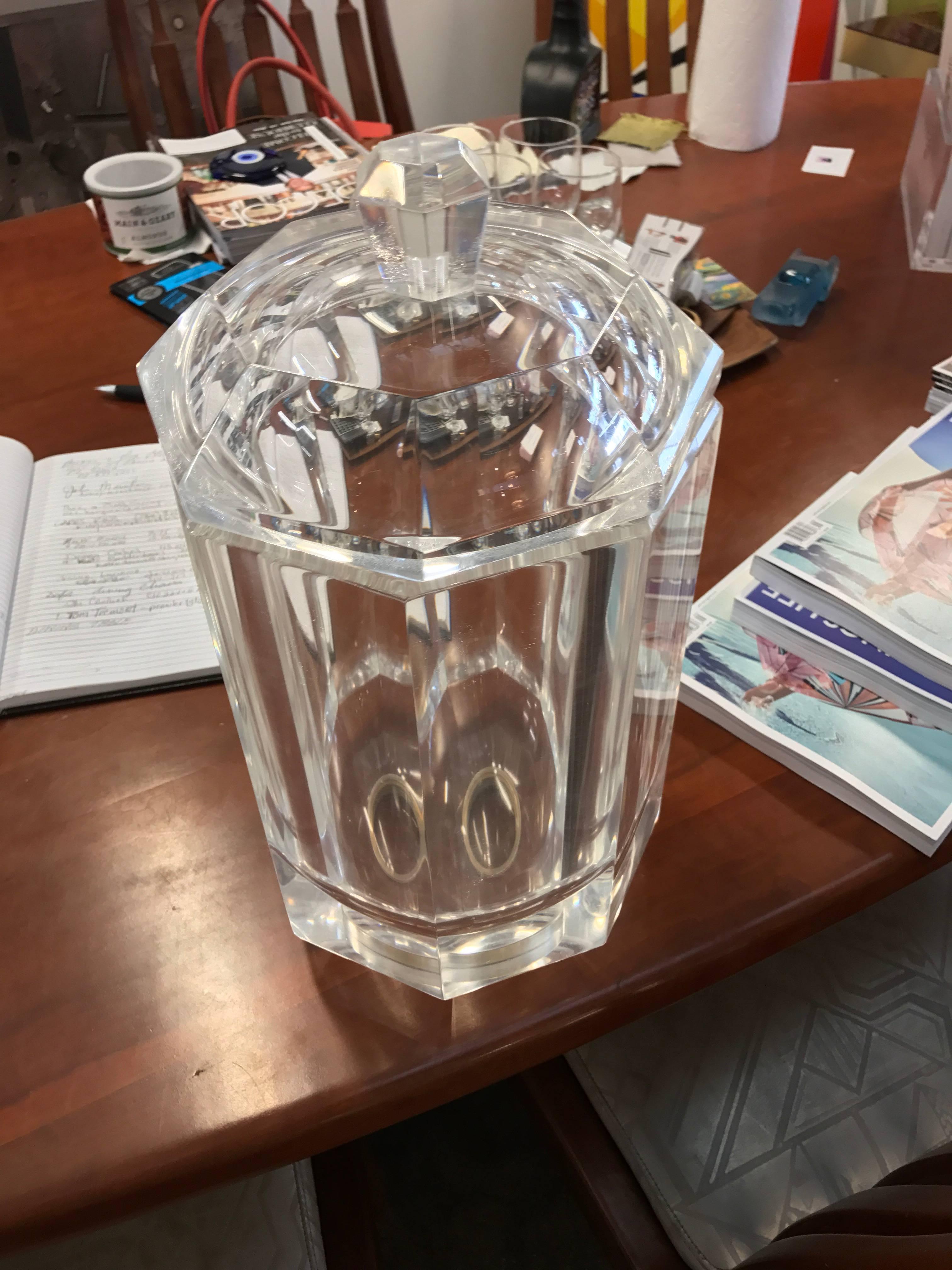 A vintage Lucite wine cooler or ice bucket with its original top. The top unscrews and can be used as an ice bucket or set on a table. The base is frosted. We have had it lightly polished although there is some age crazing and minor wear. Hard to