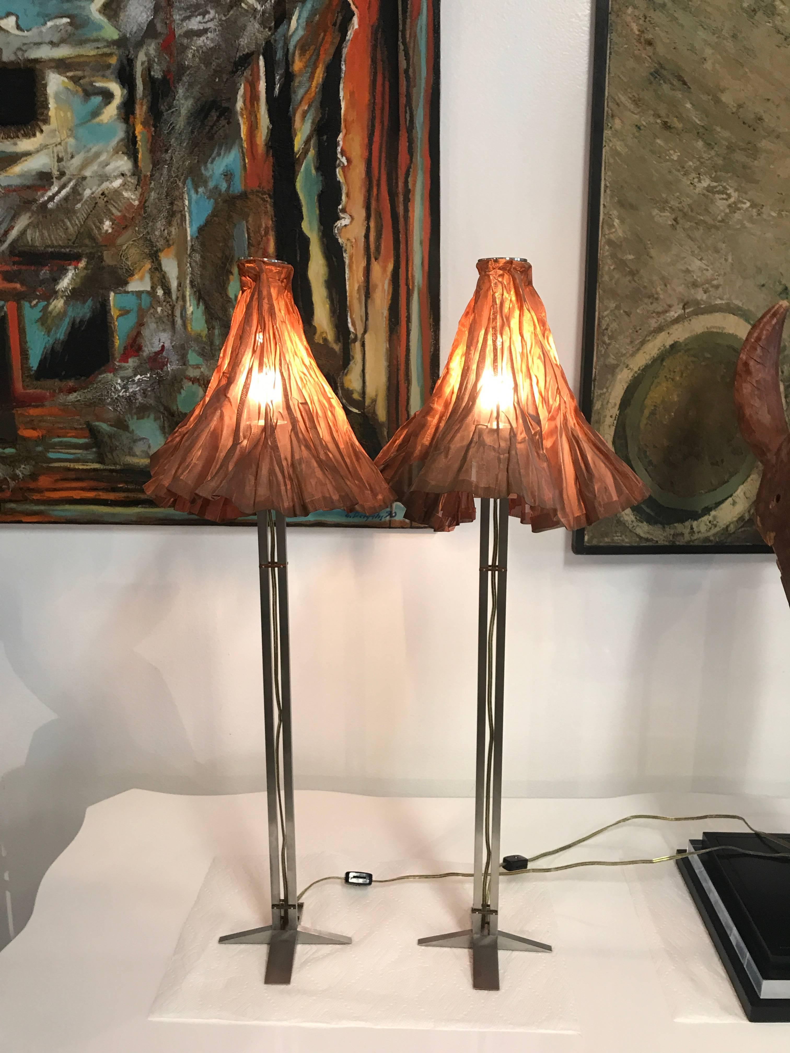 A nice pair of artisan made lamps with nice metal mesh shades. Pretty Industrial design. They are in good shape with minor scratches and marks.