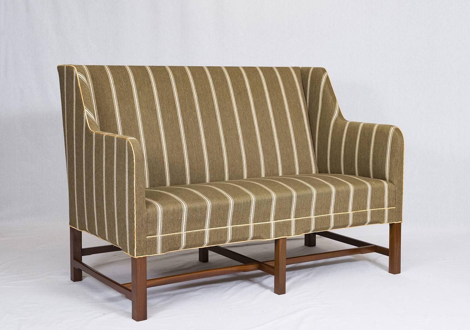 Kaare Klint settee designed in 1935 and produced by Rud Rasmussen. Has Tan leather piping.   Store formerly known as ARTFUL DODGER INC