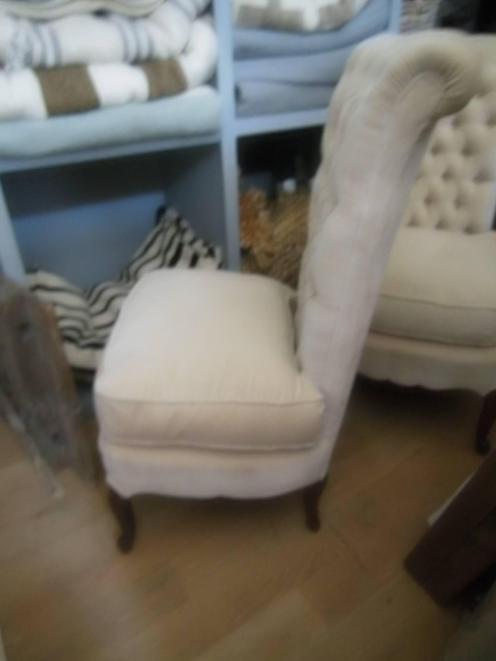 Stylish pair of vintage tufted slipper chairs in ivory velvet with plump down seat cushions.