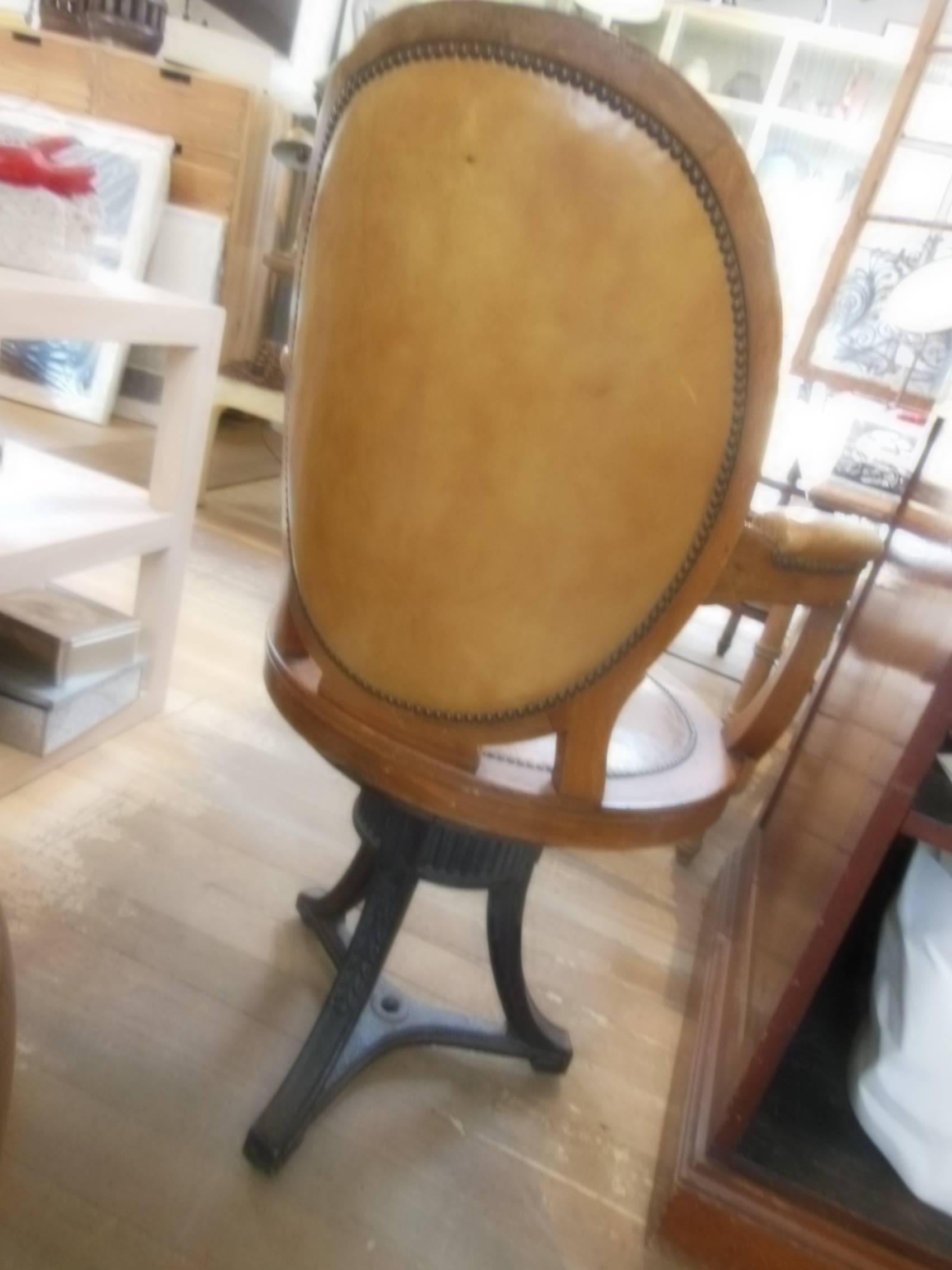 Very unusual Empire desk chair with iron base leather seat and back that swivels.
