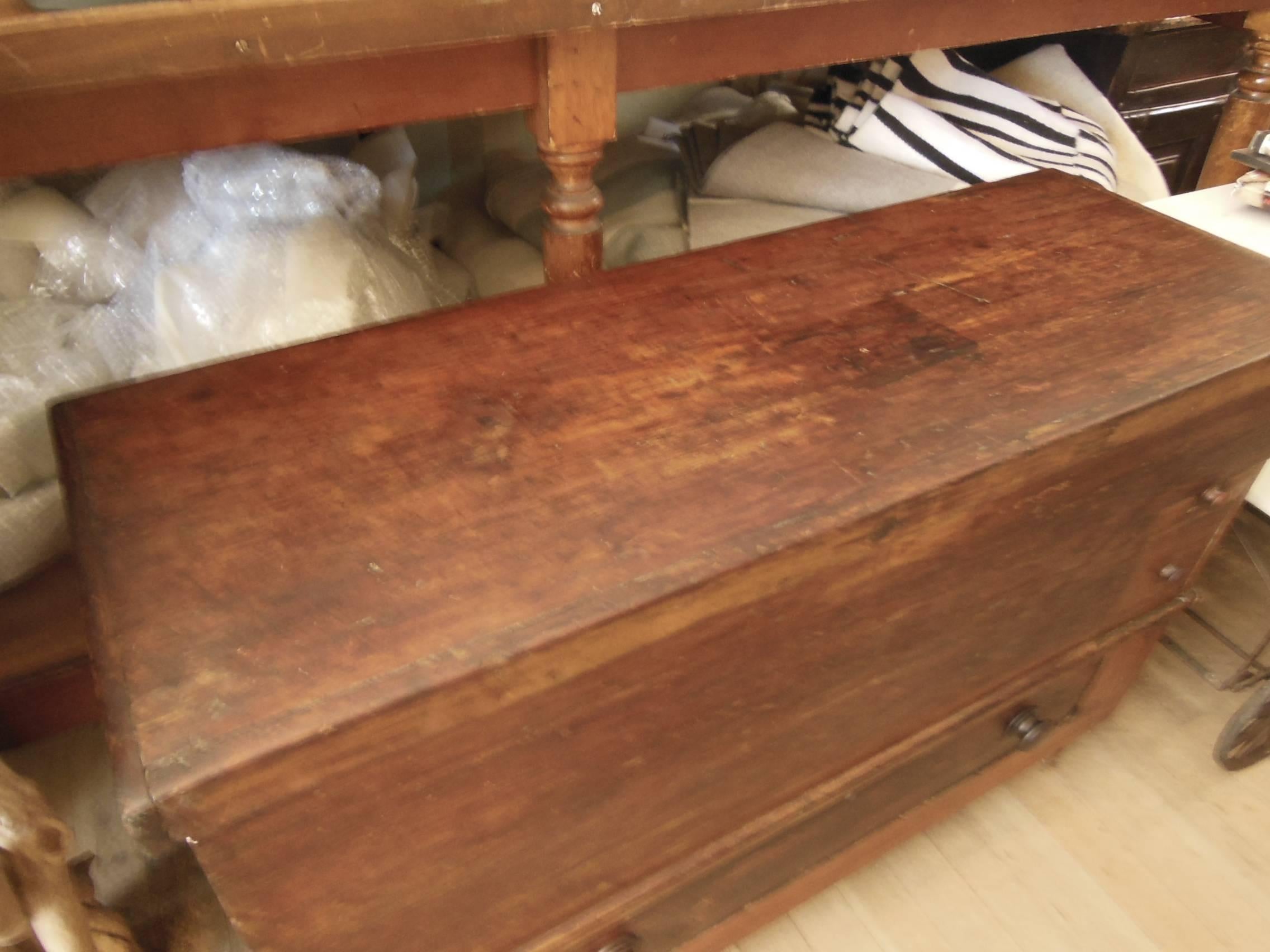 A chunky Primitive blanket chest top opens for storage inside a key drawer and big drawer outside on Primitive feet nice patina.