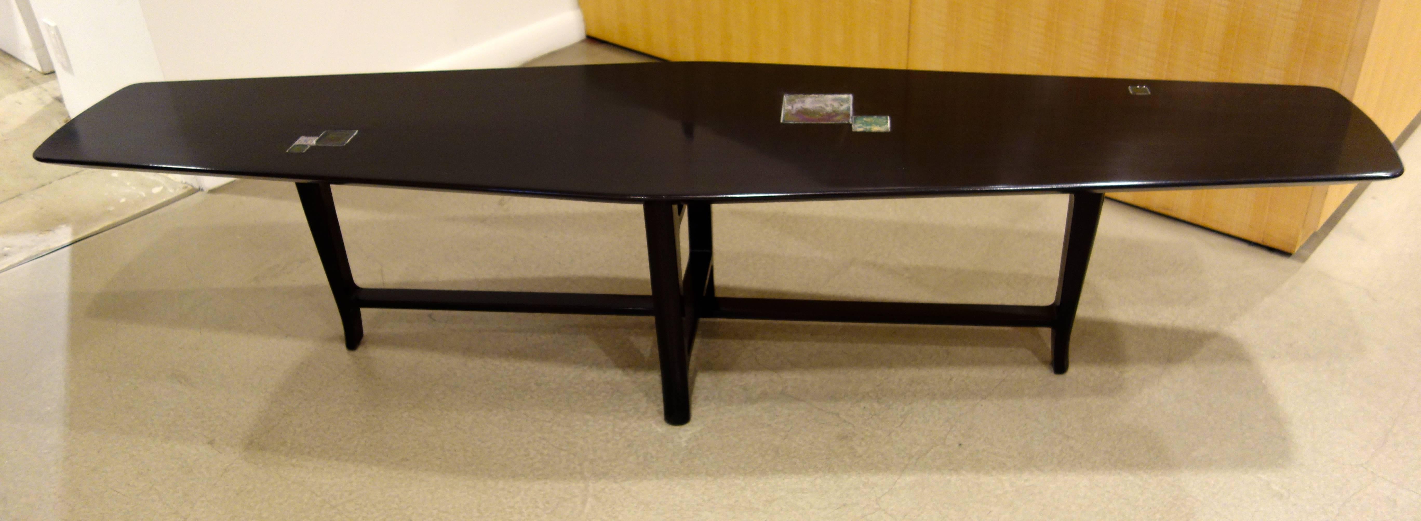 A Mid-Century Modern coffee table by Edward Wormley for Dunbar's 1957 Janus collection, model 5623N, the elongated bowed, rectangular walnut form finished in a very dark brown inset with six Tiffany Studio Favrile tiles in iridescent shades of