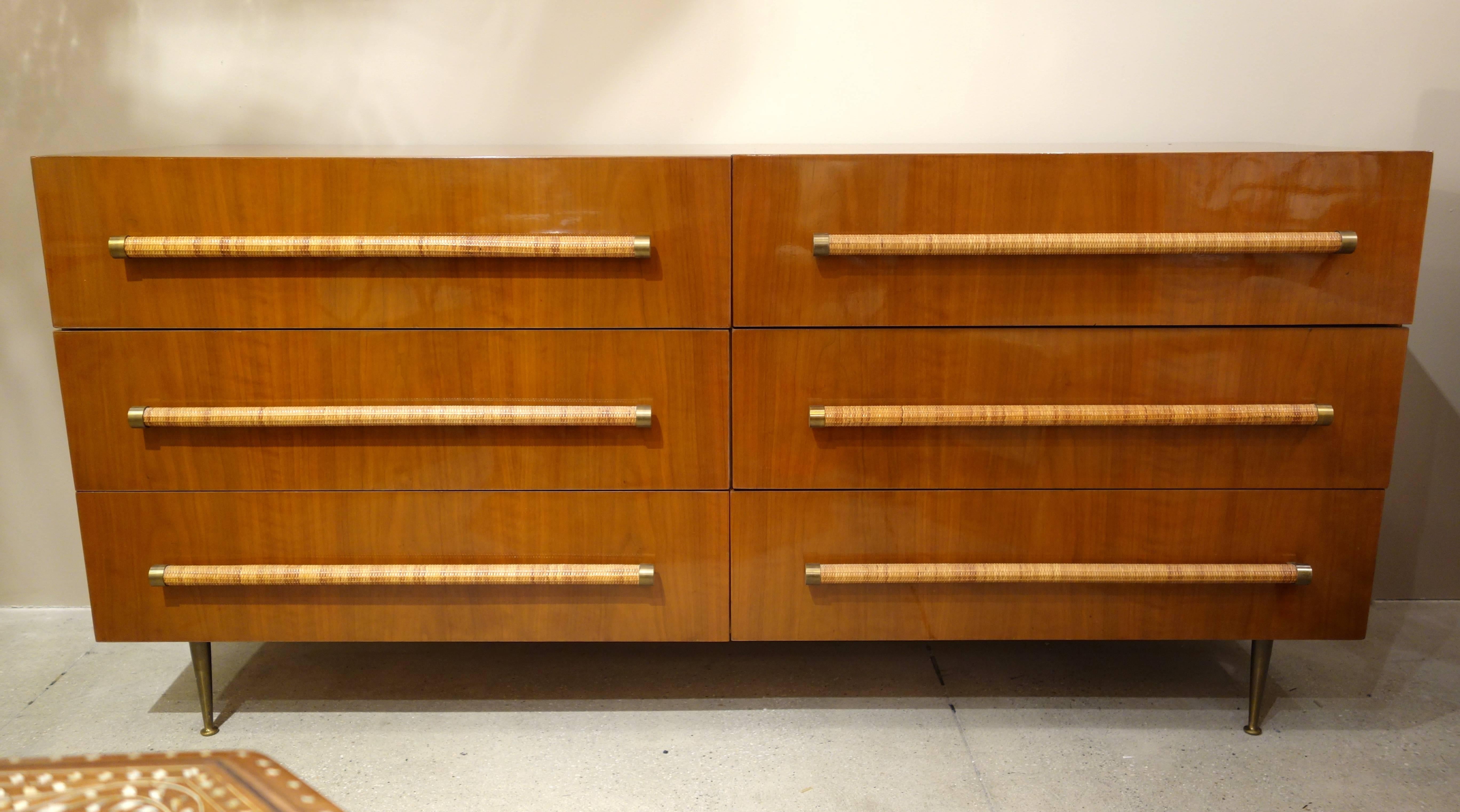T.H. Robsjohn-Gibbings for Widdicomb walnut dresser or chest finished on four sides featuring six drawers with elongated raffia, brass capped pulls resting on brass legs, the inside drawers with removable dividers.