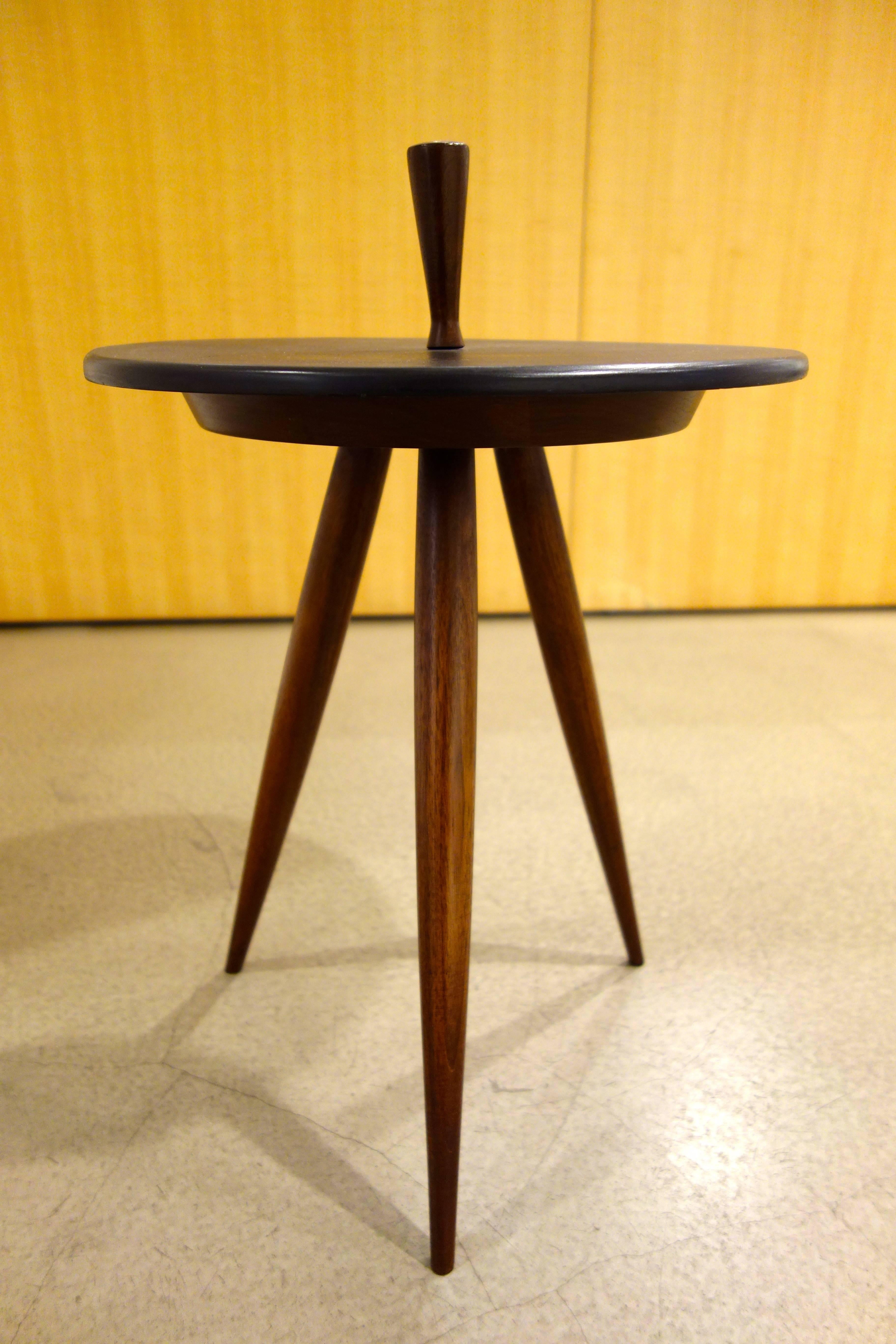 A midcentury tripod walnut and slate occasional table with shaped wood finial.