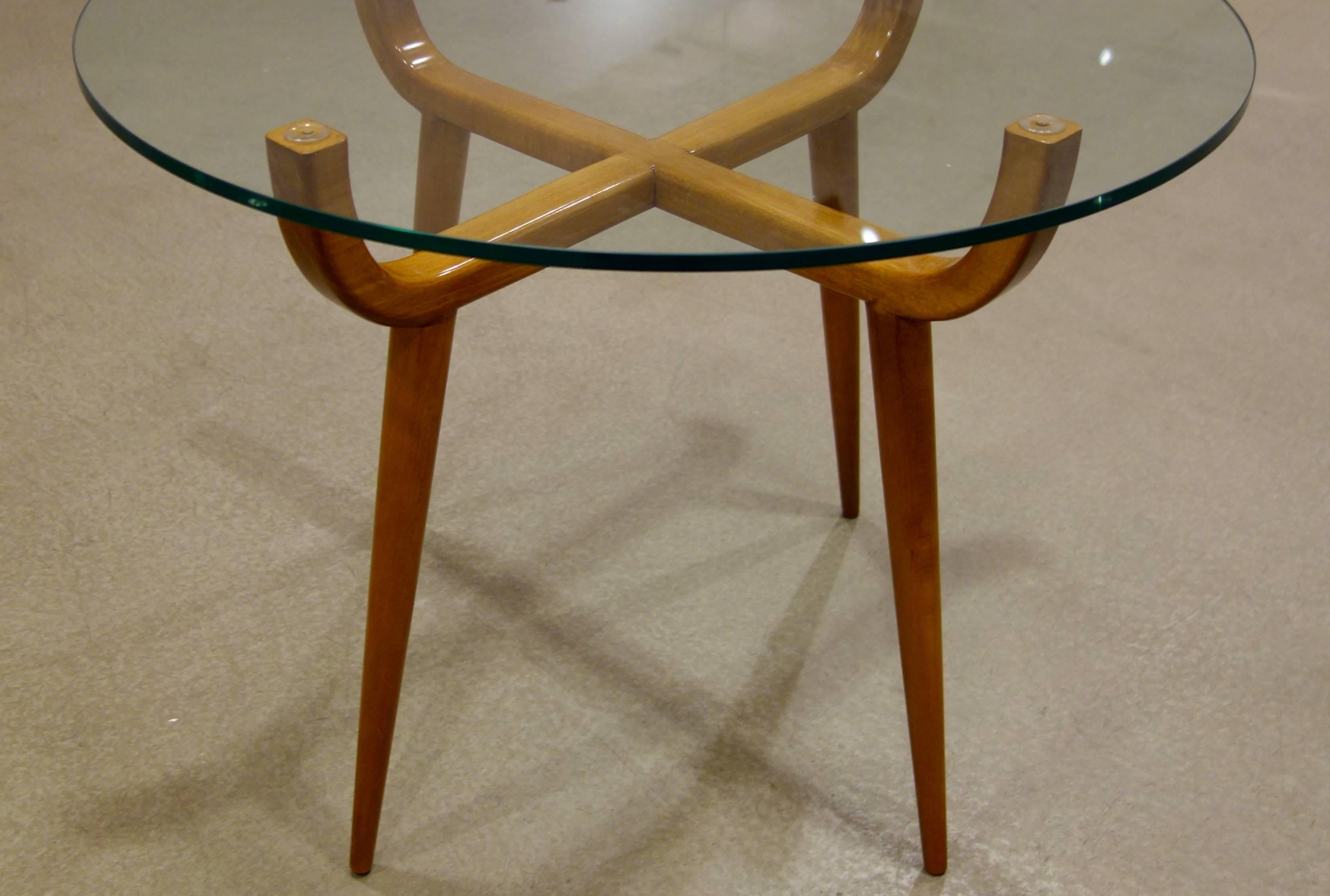 A pair of Mid-Century Italian fruitwood side or end tables, the glass tops resting on upturned cross stretchers supported by four tapered, conical legs.