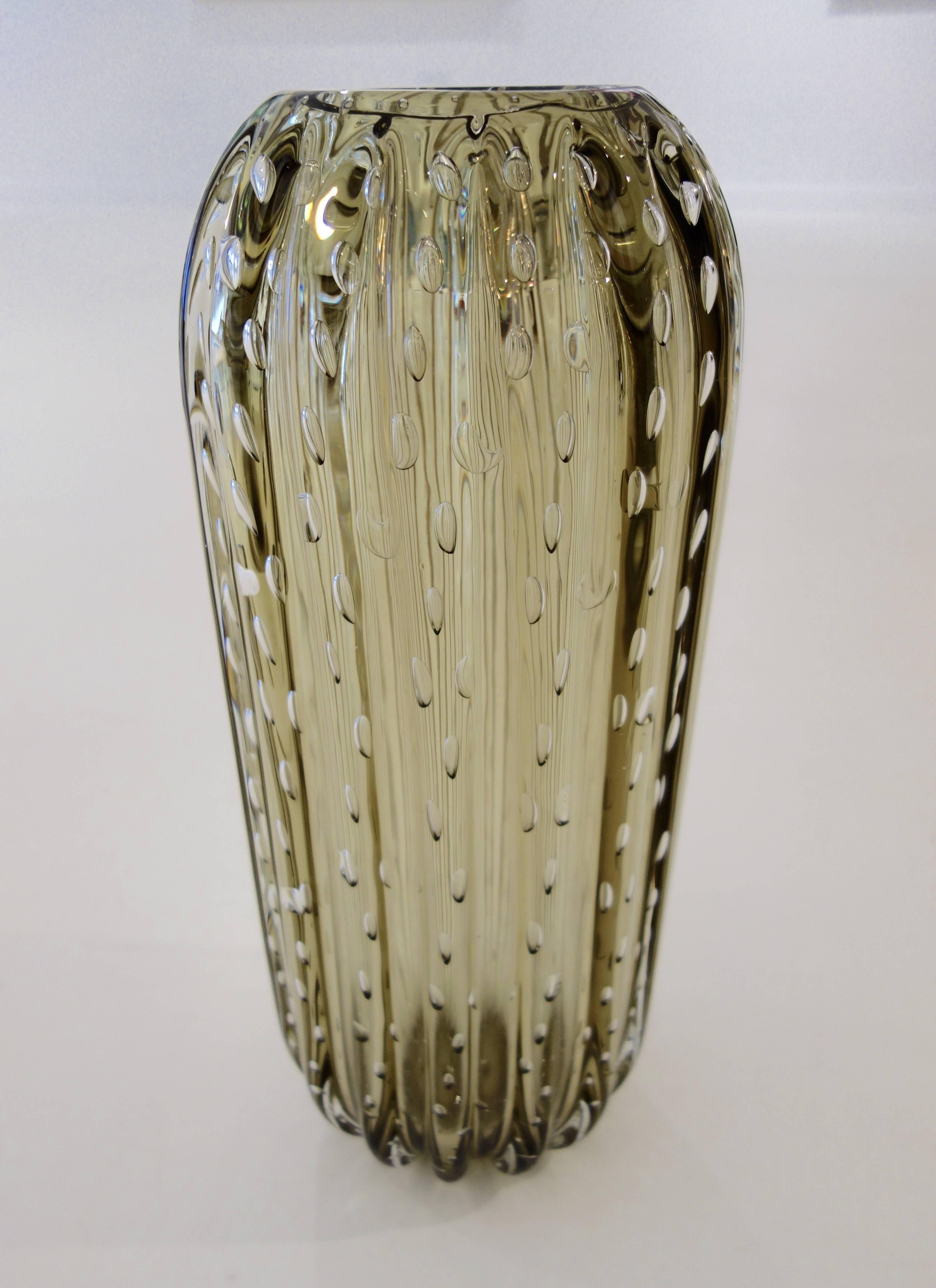 A set of three handblown thick, heavy Murano vessels by Alberto Dona in Pagliesco (straw) colored glass each fluted with controlled bubbles signed on the bottom. The dimensions of the largest listed below. The medium size vase is 14.5