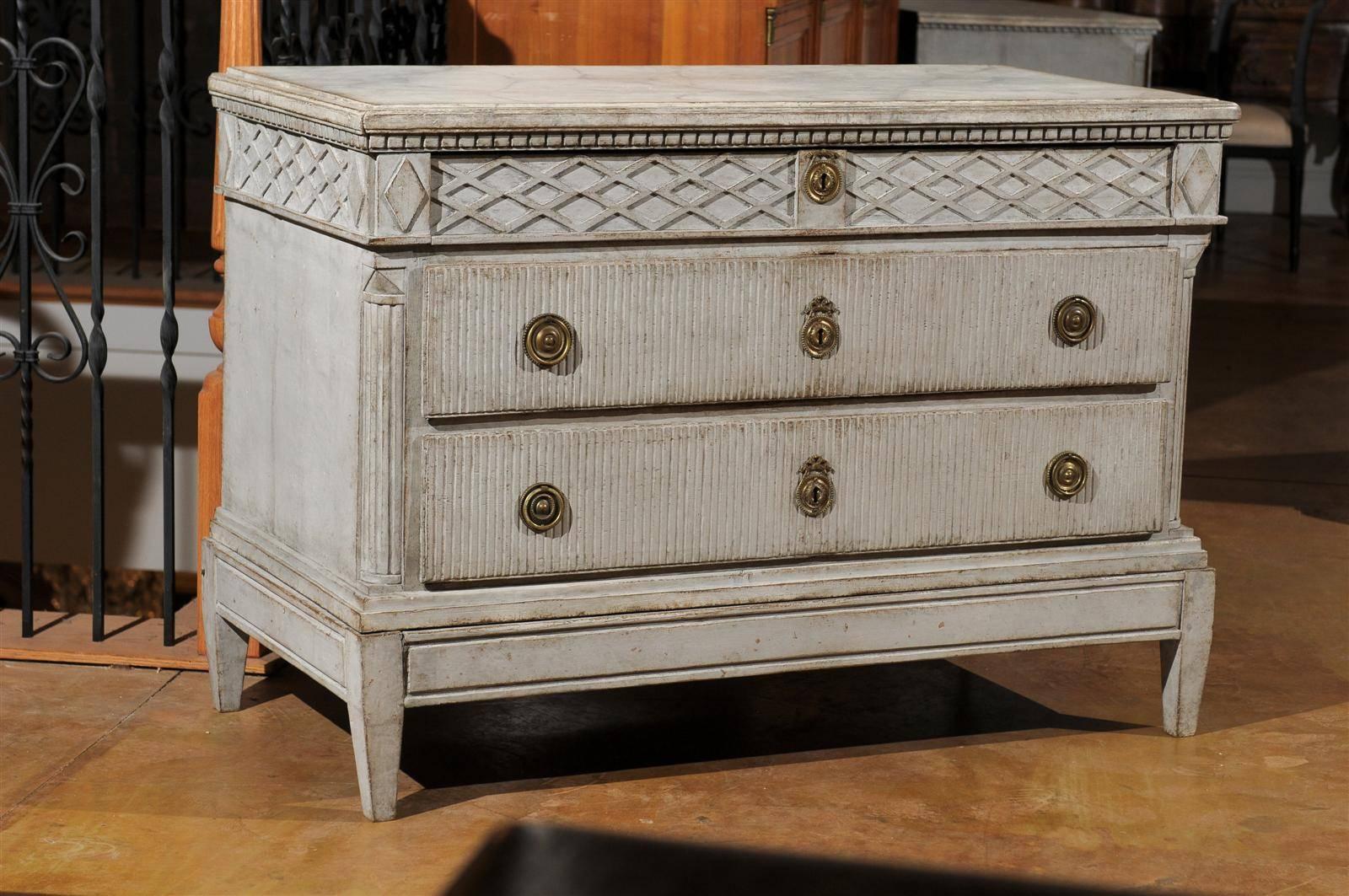 Swedish 18th century period Gustavian three-drawer commode intricately carved. Original paint and original hardware.