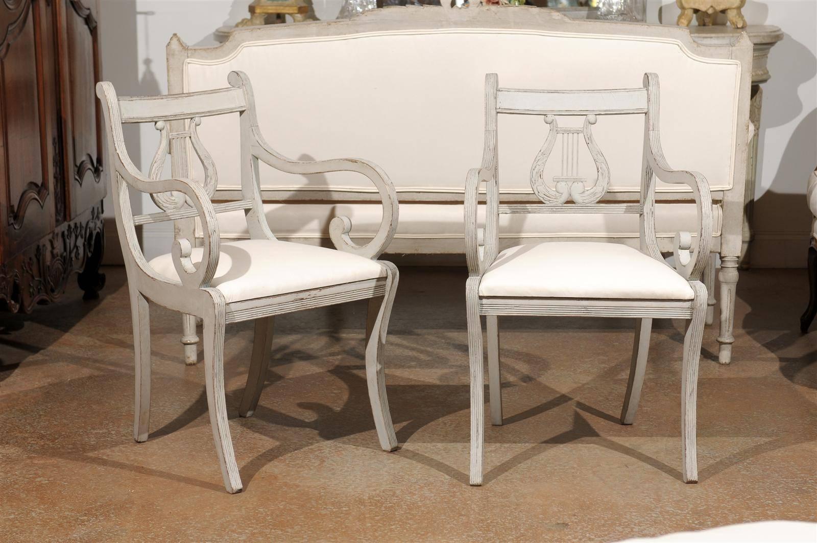 Two Swedish 1900s Lyre Back Painted Armchairs with Scrolled Arms and Saber Legs For Sale