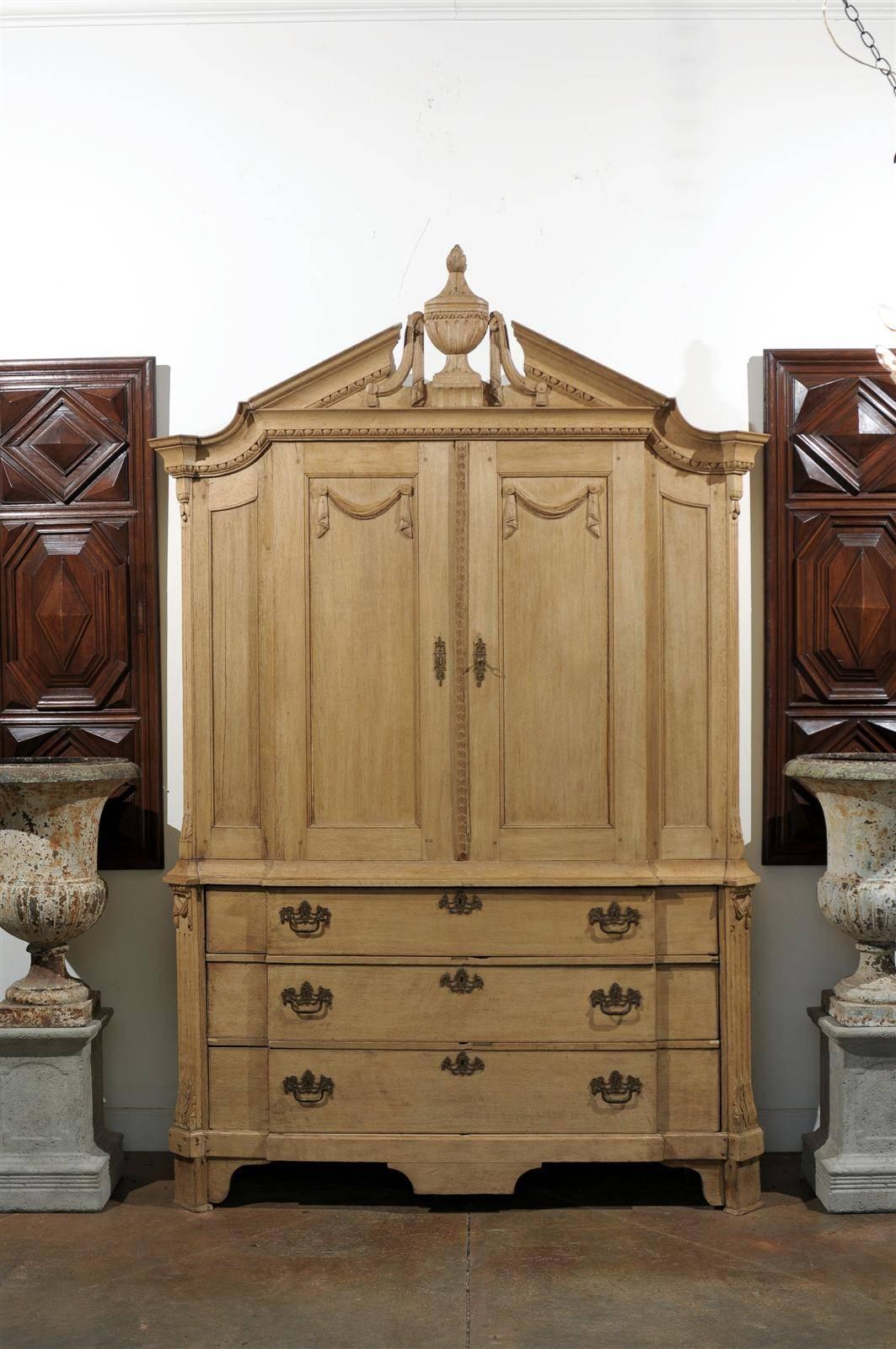 Dutch 18th century buffet deux corps in natural oak. Richly carved with an upper cabinet over three drawers, circa 1750.