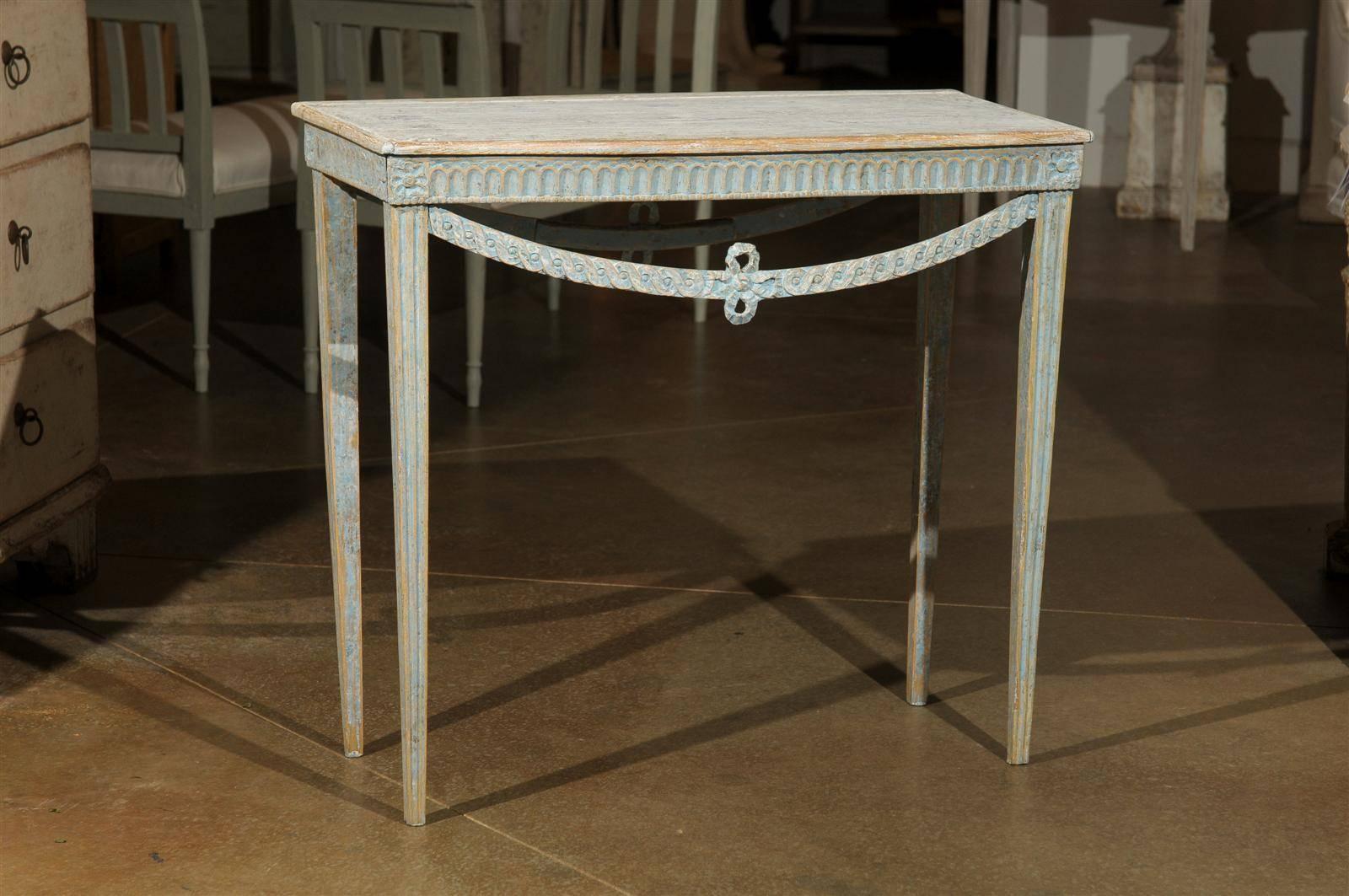 Swedish 18th century period Gustavian console table. Carved on all four sides. Painted in a pale blue with pale grey top. Carved swags. Original paint, circa 1780. This piece is listed in its original unrestored antique condition. Any wear or fading