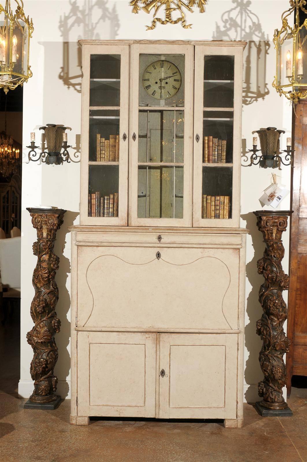 Swedish 19th century clock cabinet with three glass doors over a compartimilized fall front desk and lower two-door cabinet. Signed "Olof Mansson Snickare" and dated 1878. Made in Farlila, Halsingland. Original clock mechanism, locks and