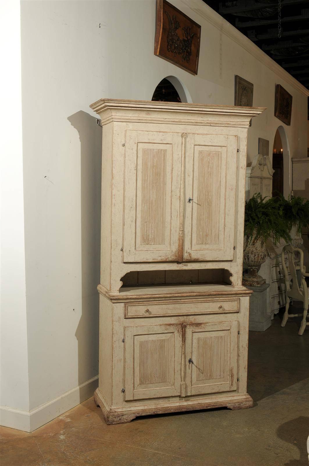 A Swedish Gustavian early 19th century painted wood two-part cabinet from the county of Jämtland. Born in the second decade of the 19th century in Jämtland, a county situated in the middle of Sweden, this Swedish tall cabinet features a large molded