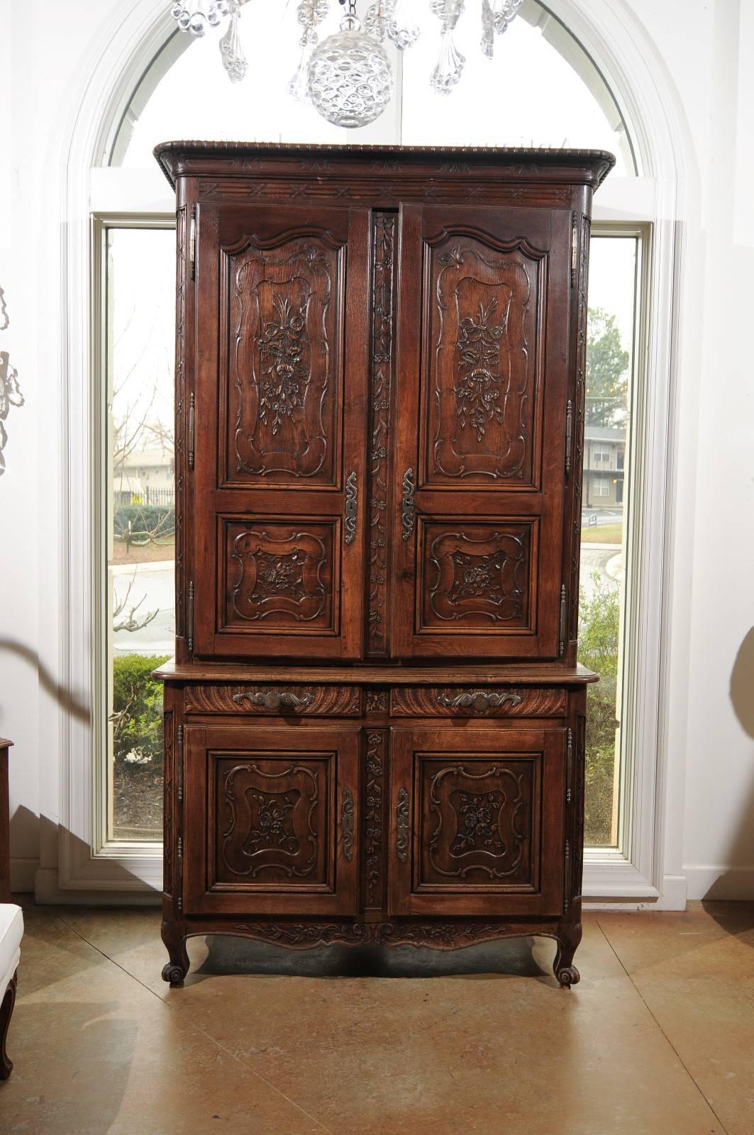 An early 19th century French carved oak buffet à deux-corps from the Picardie region of France. This tall French two-piece cabinet was born in the first decade of the 19th century in the Northern region of Picardie, under the reign of Emperor