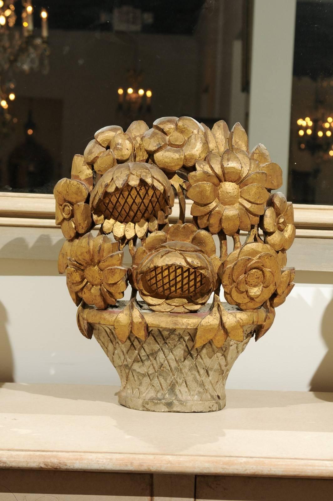 This French late 18th century Louis XVI period decorative carving features a slightly concave ribbed vase holding an exquisite giltwood bouquet of flowers. Two sunflowers (tournesols in French) are drawing all the attention. As the French word